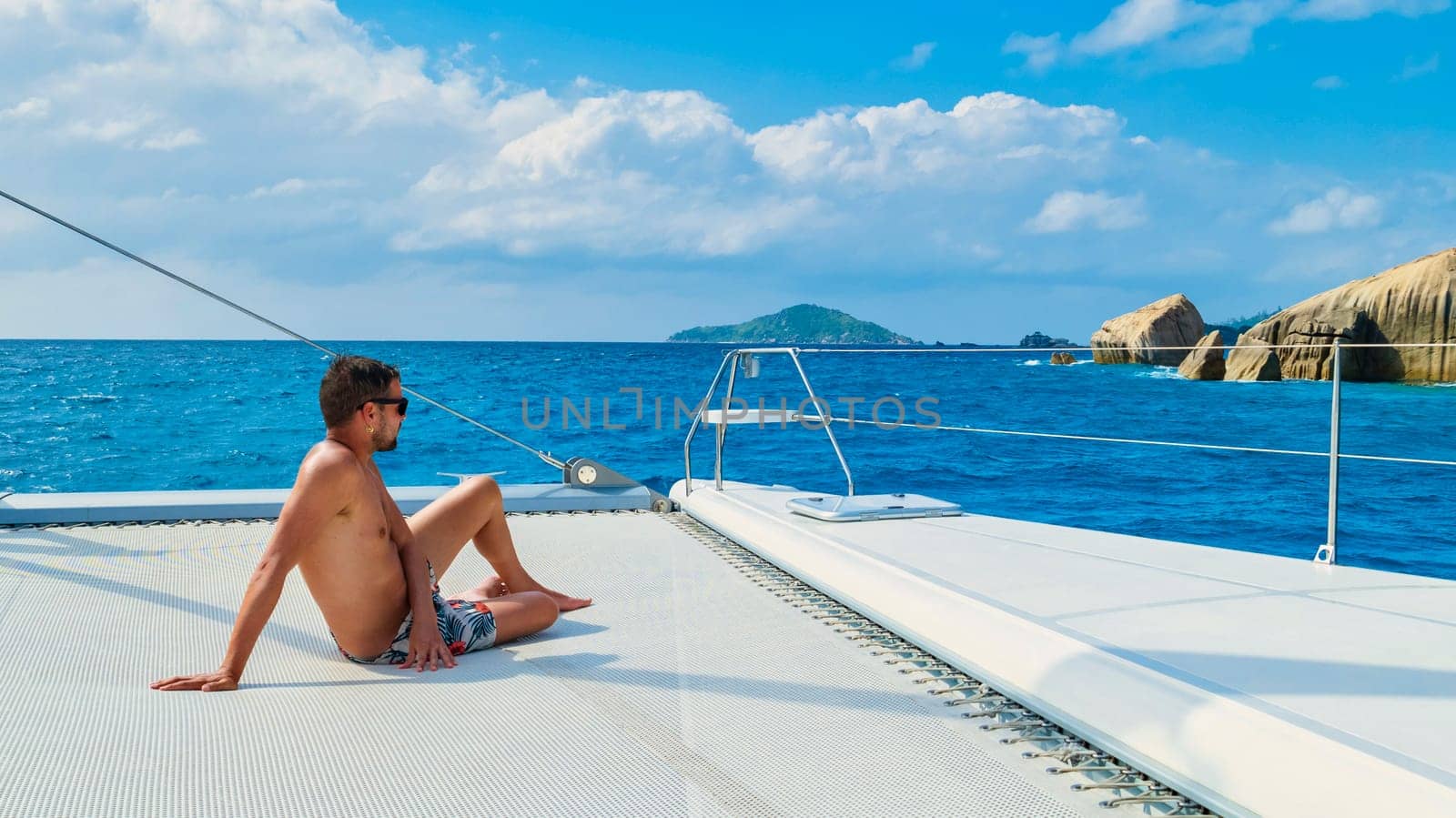 Young men on a trip with Sailing boat at the Tropical Seychelles Islands by fokkebok