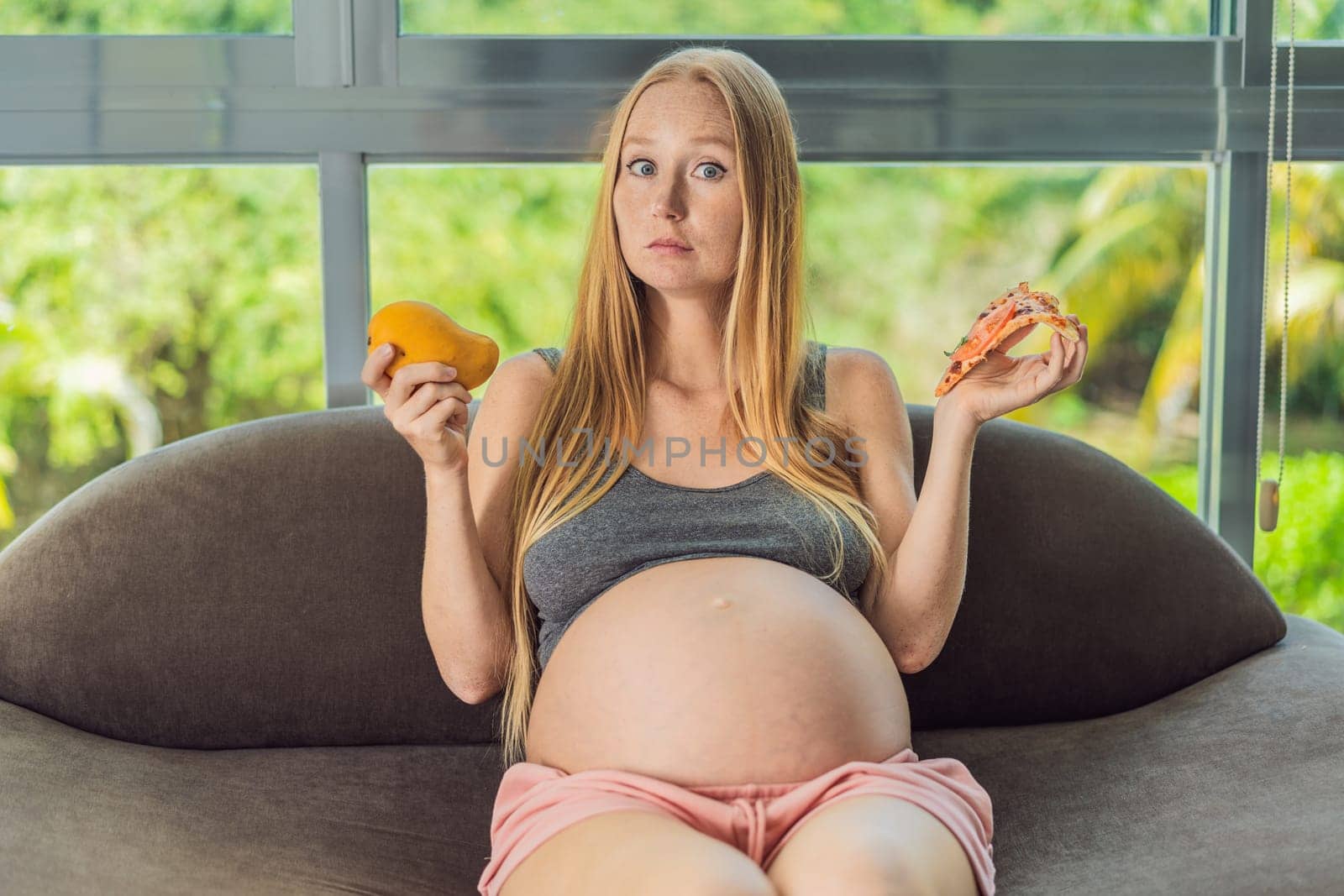 A pregnant woman faces a choice between nourishing, wholesome food and tempting fast food, highlighting the importance of healthy dietary decisions during pregnancy by galitskaya