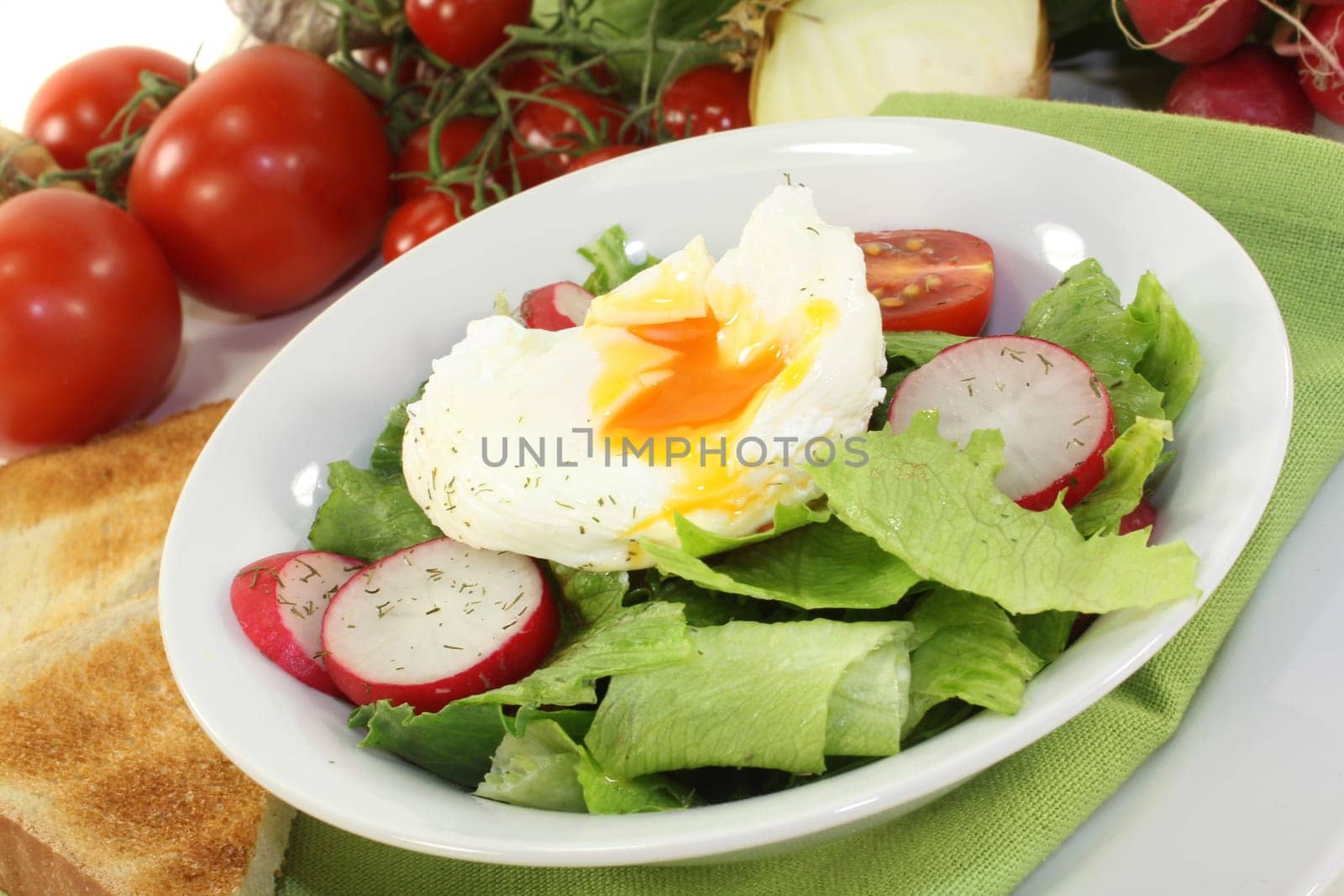 mixed colorful salad with poached egg