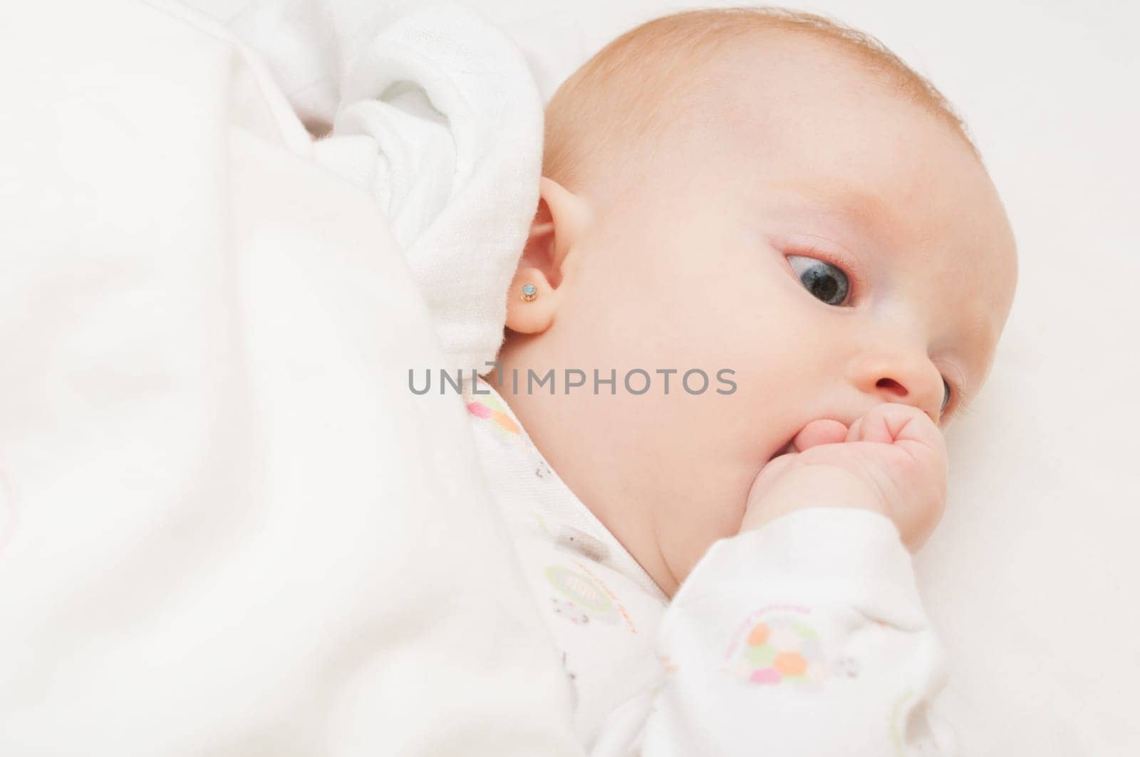 Baby Lying on Back Sucking its Hand