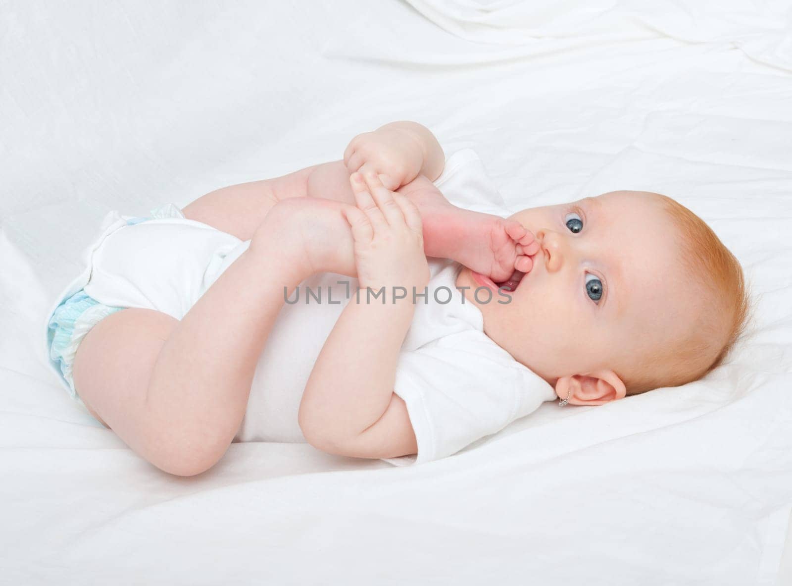 Cute Baby Girl Sucking Her Toes on White Background