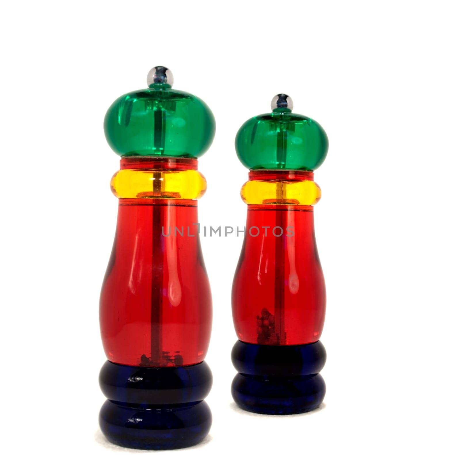 Colorful kitchenware salt and pepper grinders over white background