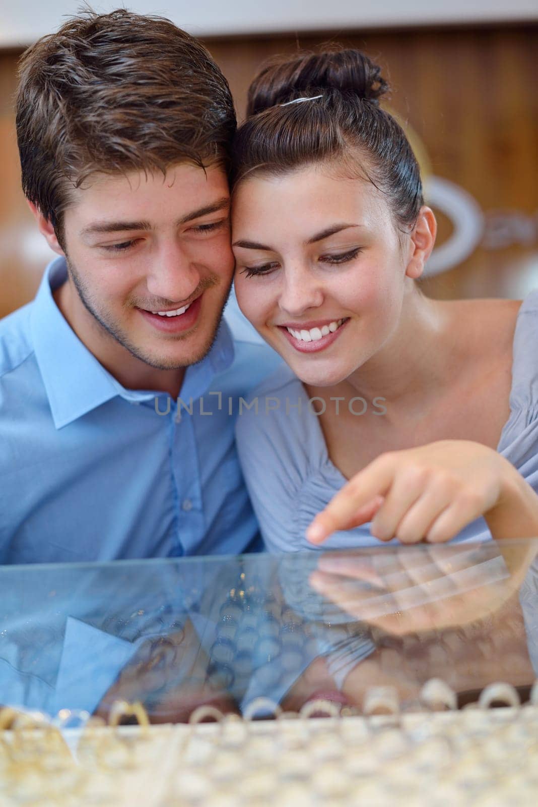 happy young romantic couple in love buy jewelry ring in luxury store