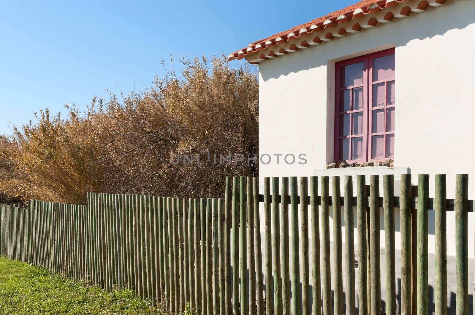Wooden fence next a country house