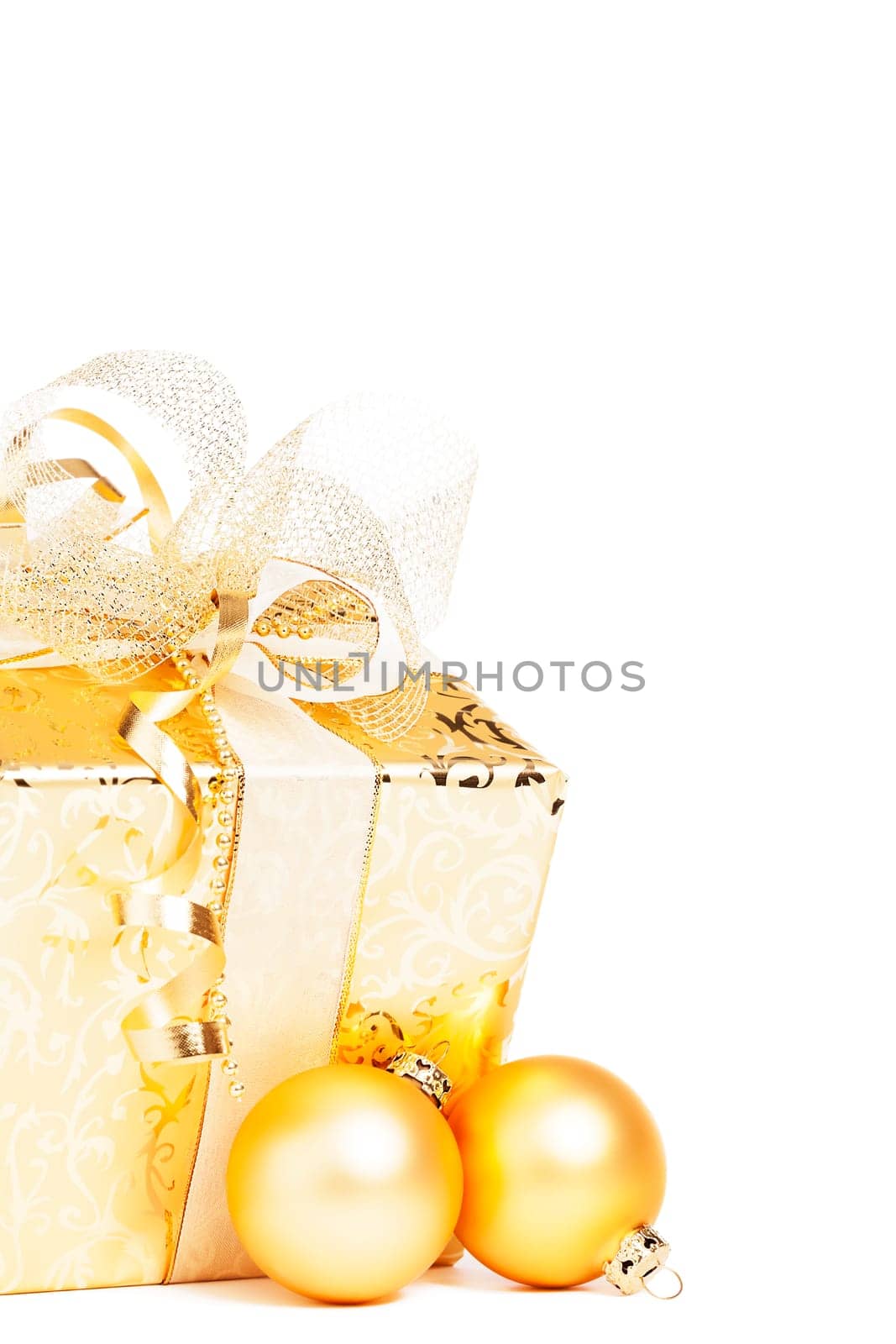 Golden Christmas gift with golden baubles on white background