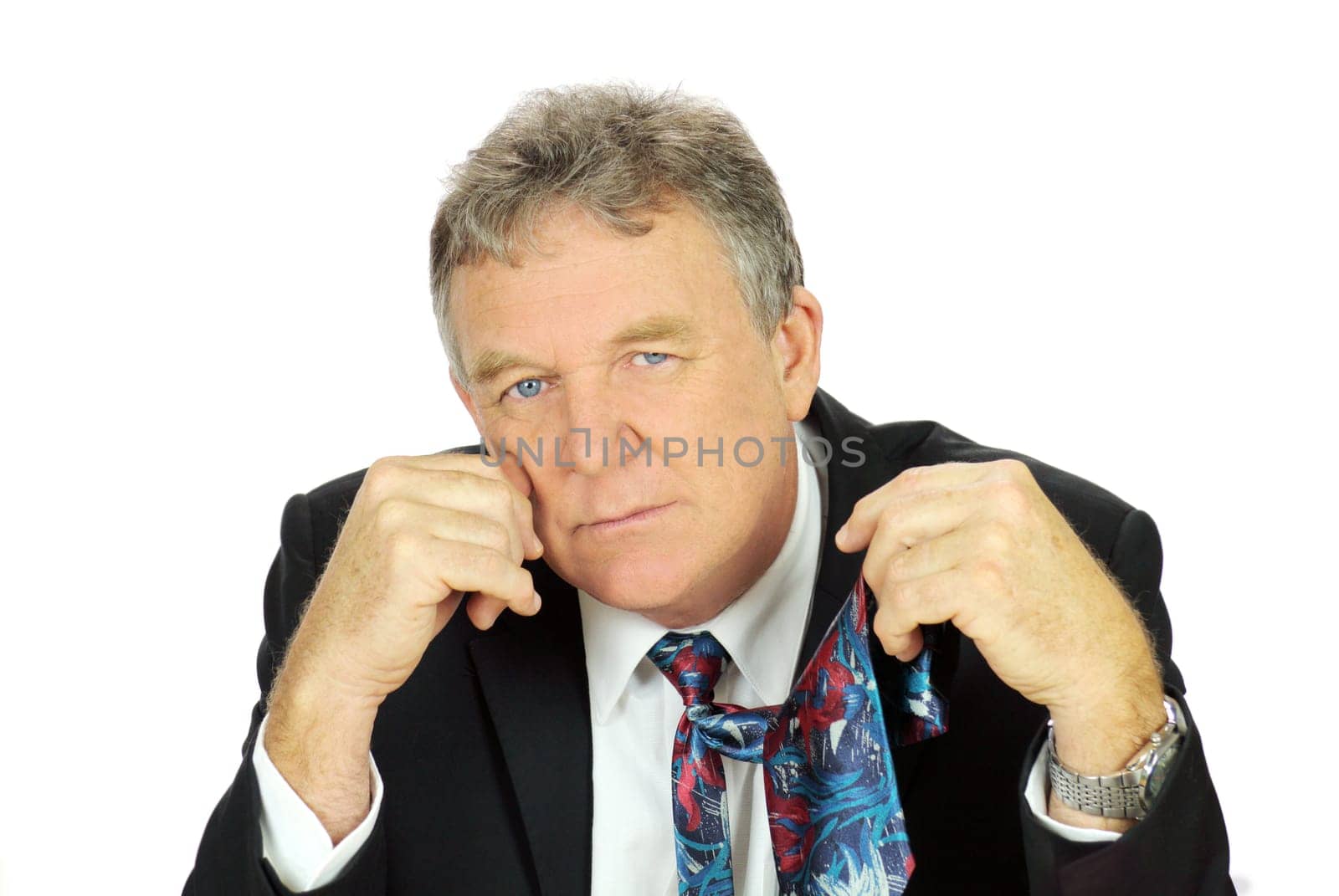 Middle aged depressed businessman looking frustrated holding his tie.