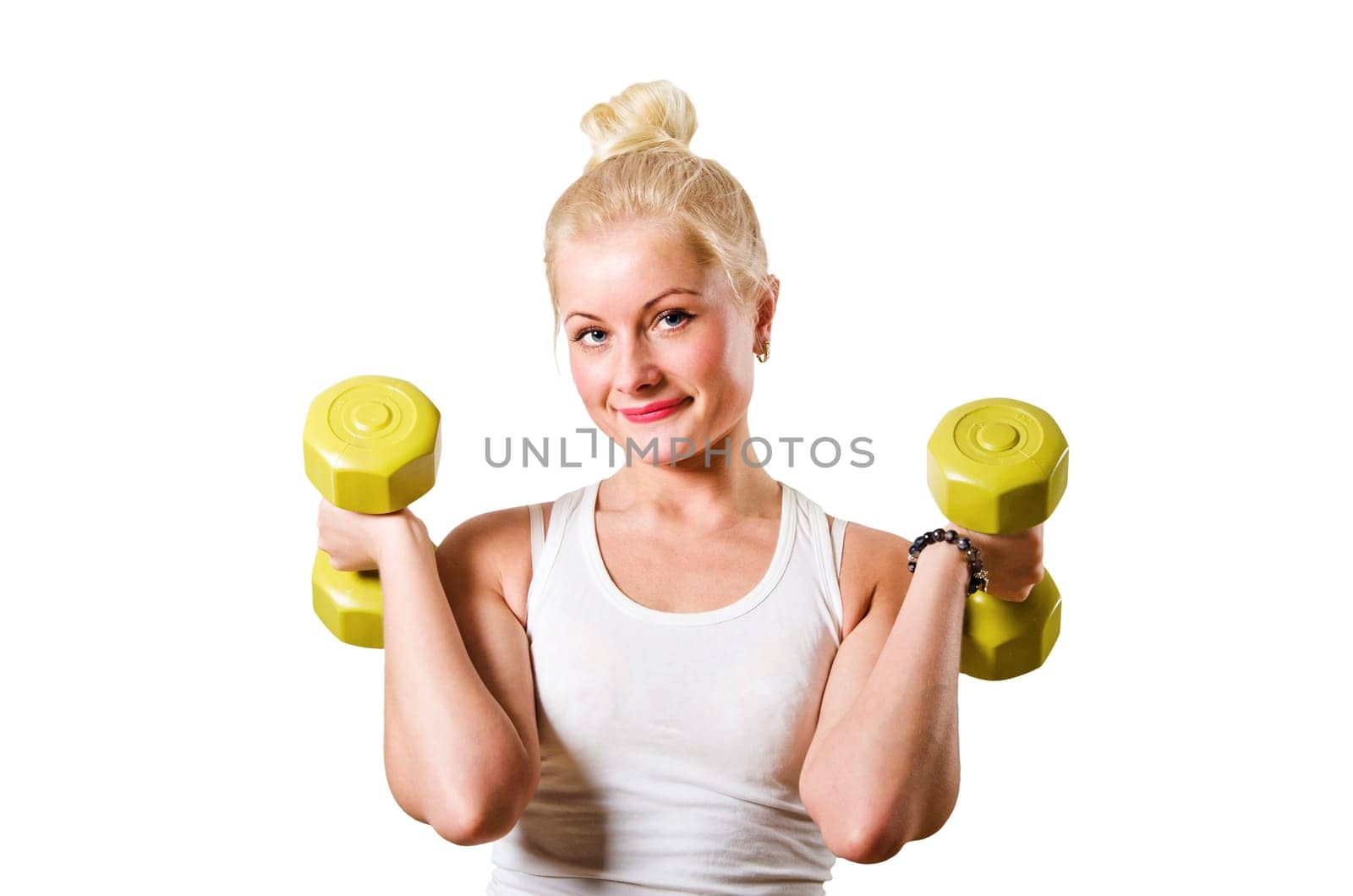 The young woman is engaged with dumbbells