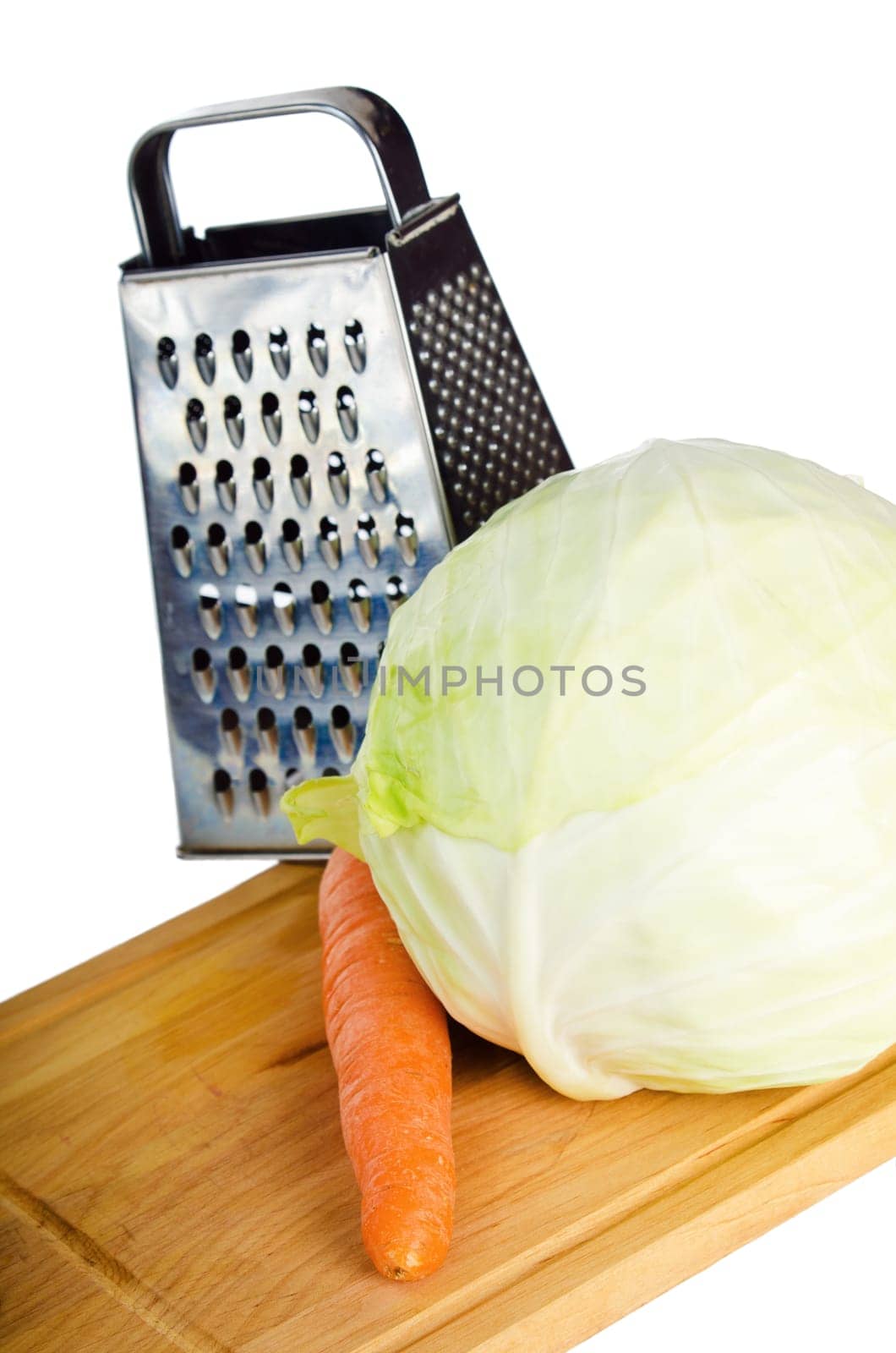 Cabbage and carrots on a kitchen board, it is isolated on white