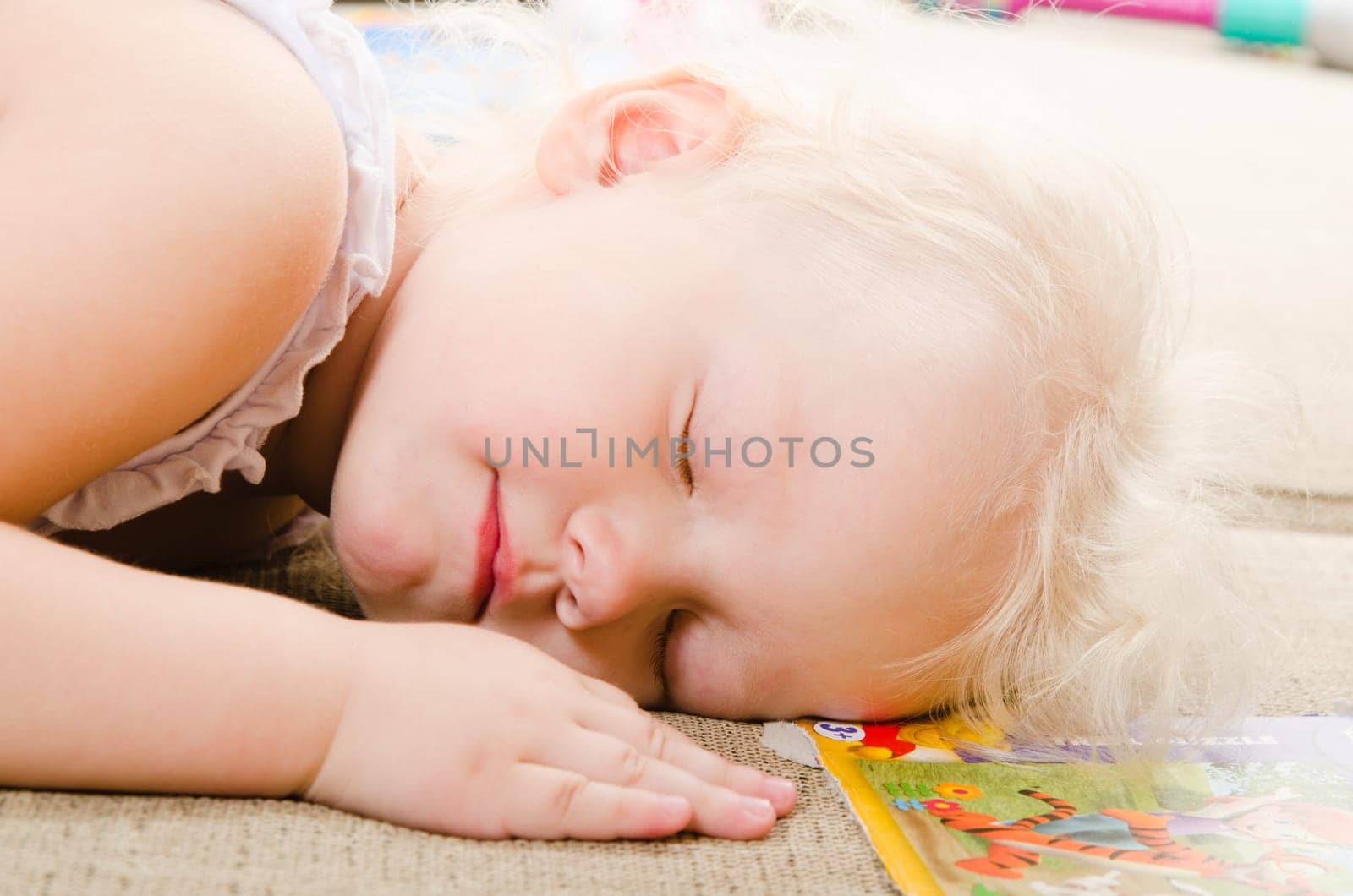 little girl fell asleep after playing