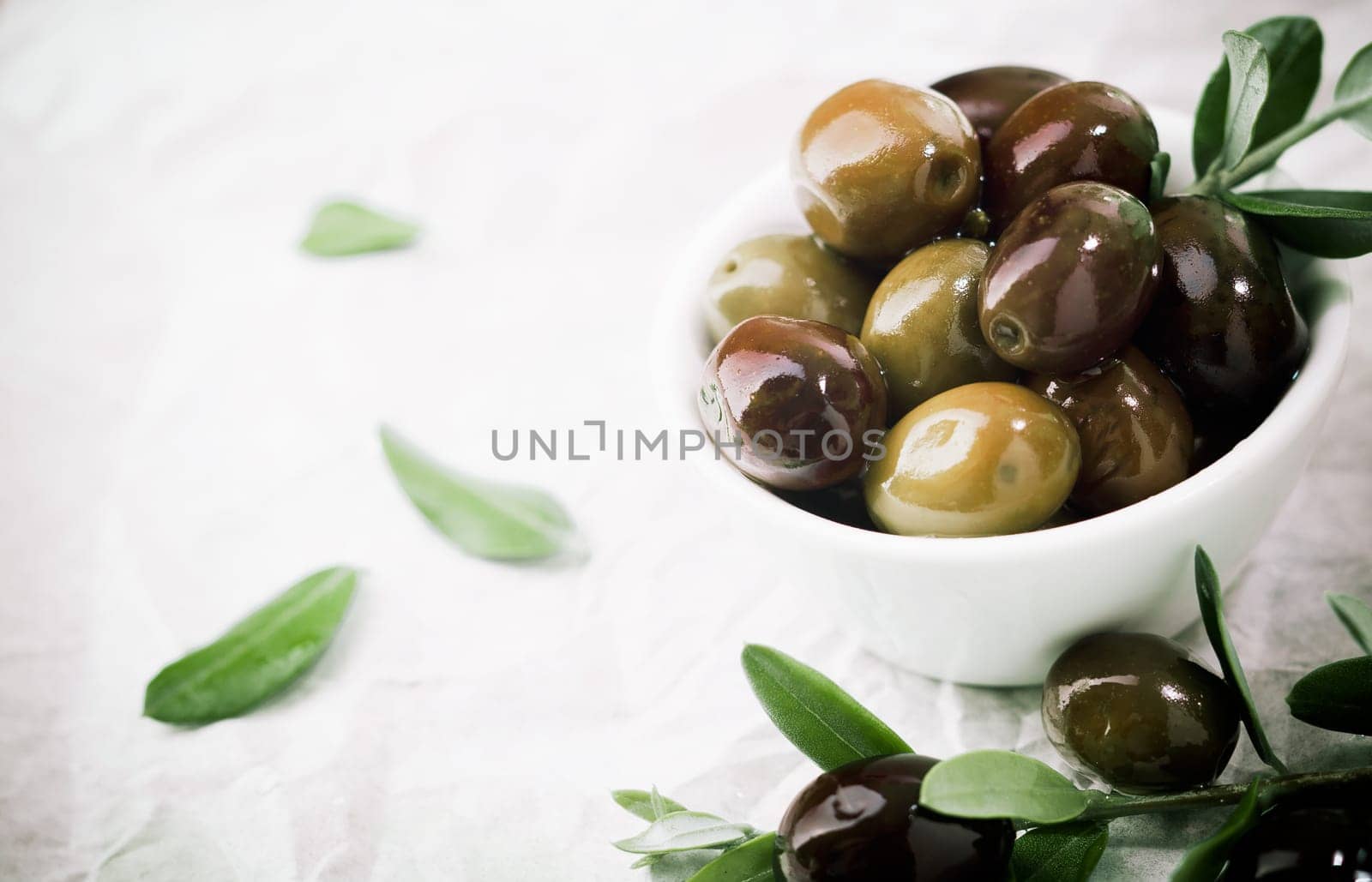 Bowl filled with fresh black olives served as an accompaniment or appetizing snack with copyspace