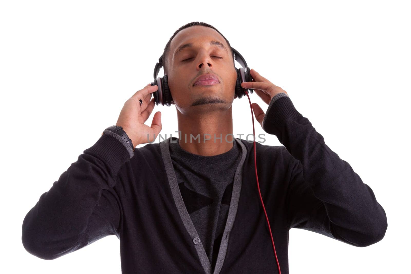 Young black man with closed eyes listening to music, isolated on white background