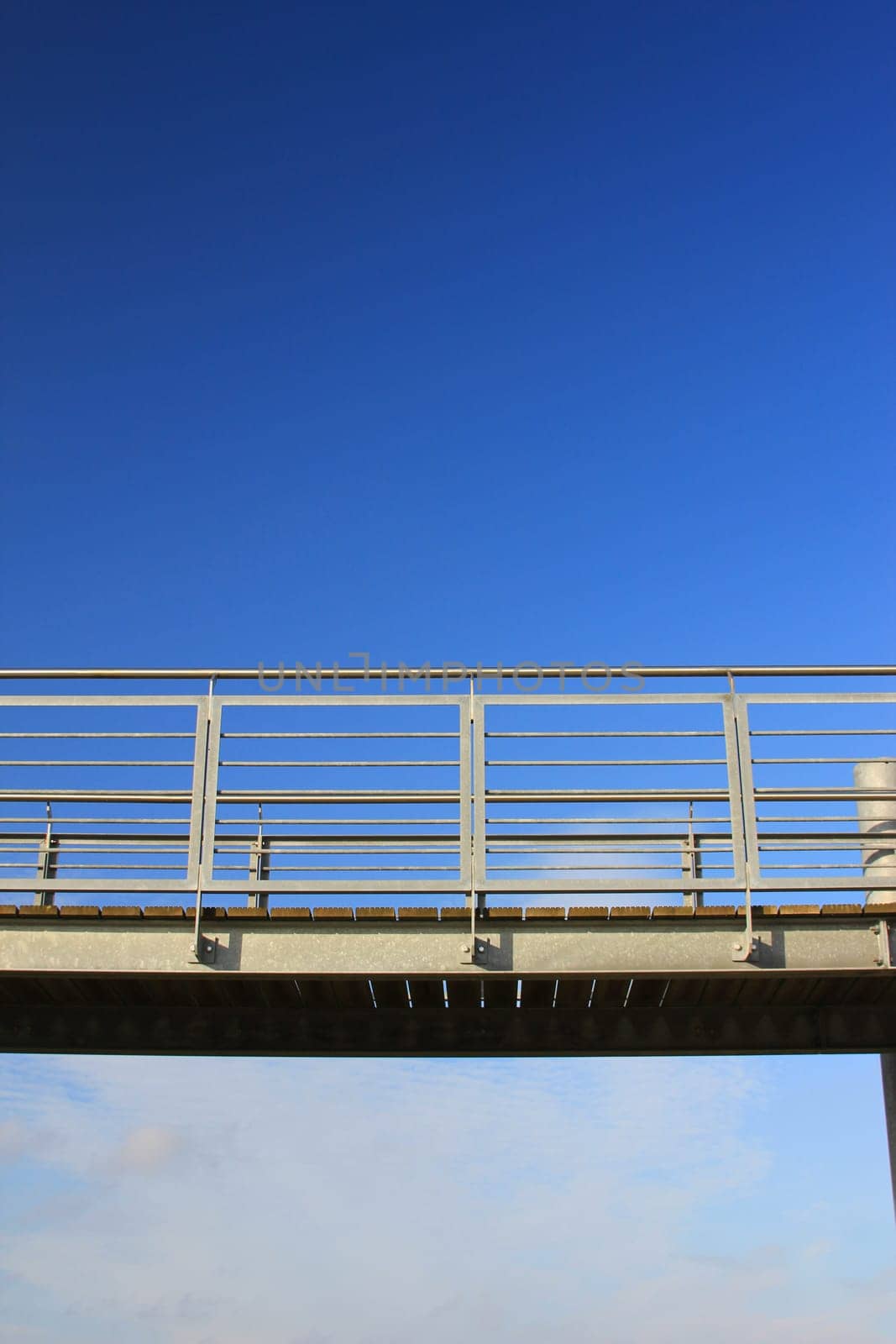 Metal walkway in front of blue sky
