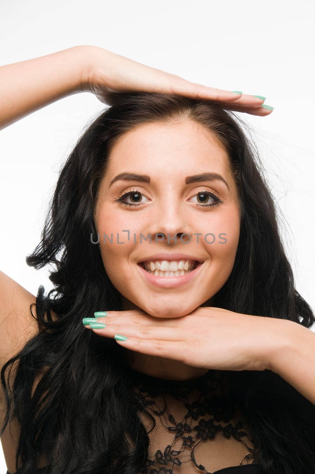 frontal head and shoulders shot of a young black-haired woman against a white background,putting the right palm on her head and holding the back of her left hand under her chin  Emote: Hand Frame