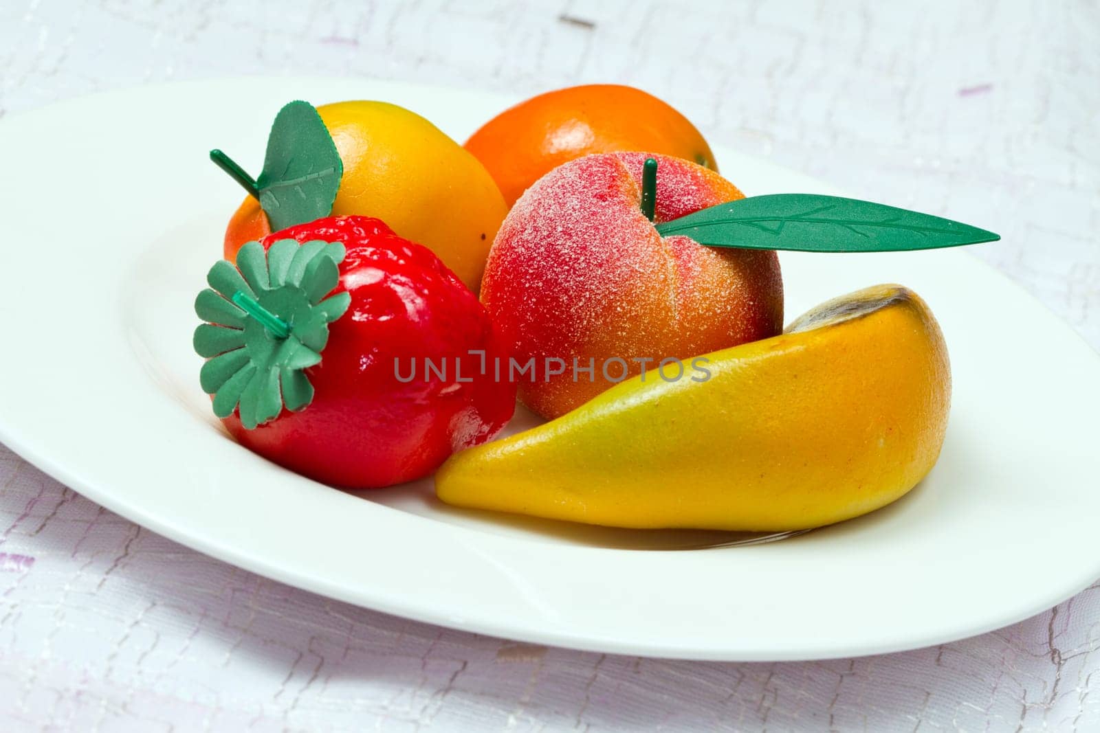 Marzipan fruit isolated on white dish