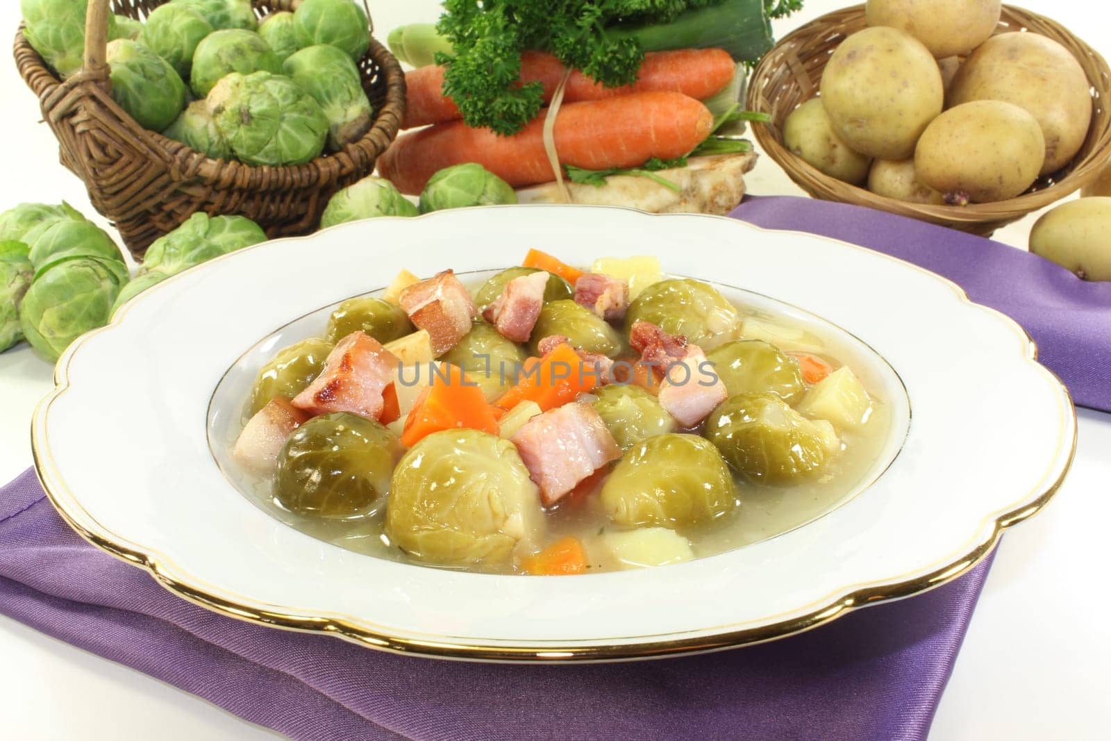 a plate of Brussels sprout stew with colorful vegetables and bacon