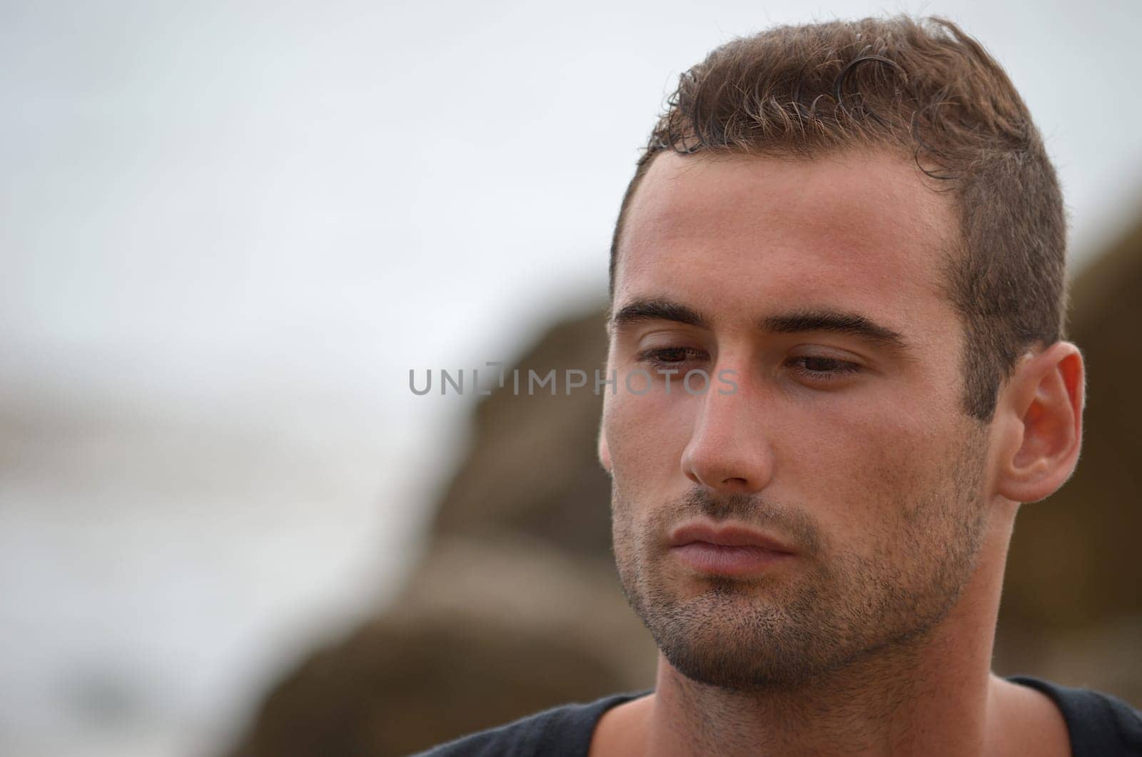 Headshot of sad or thoughtful good looking male model