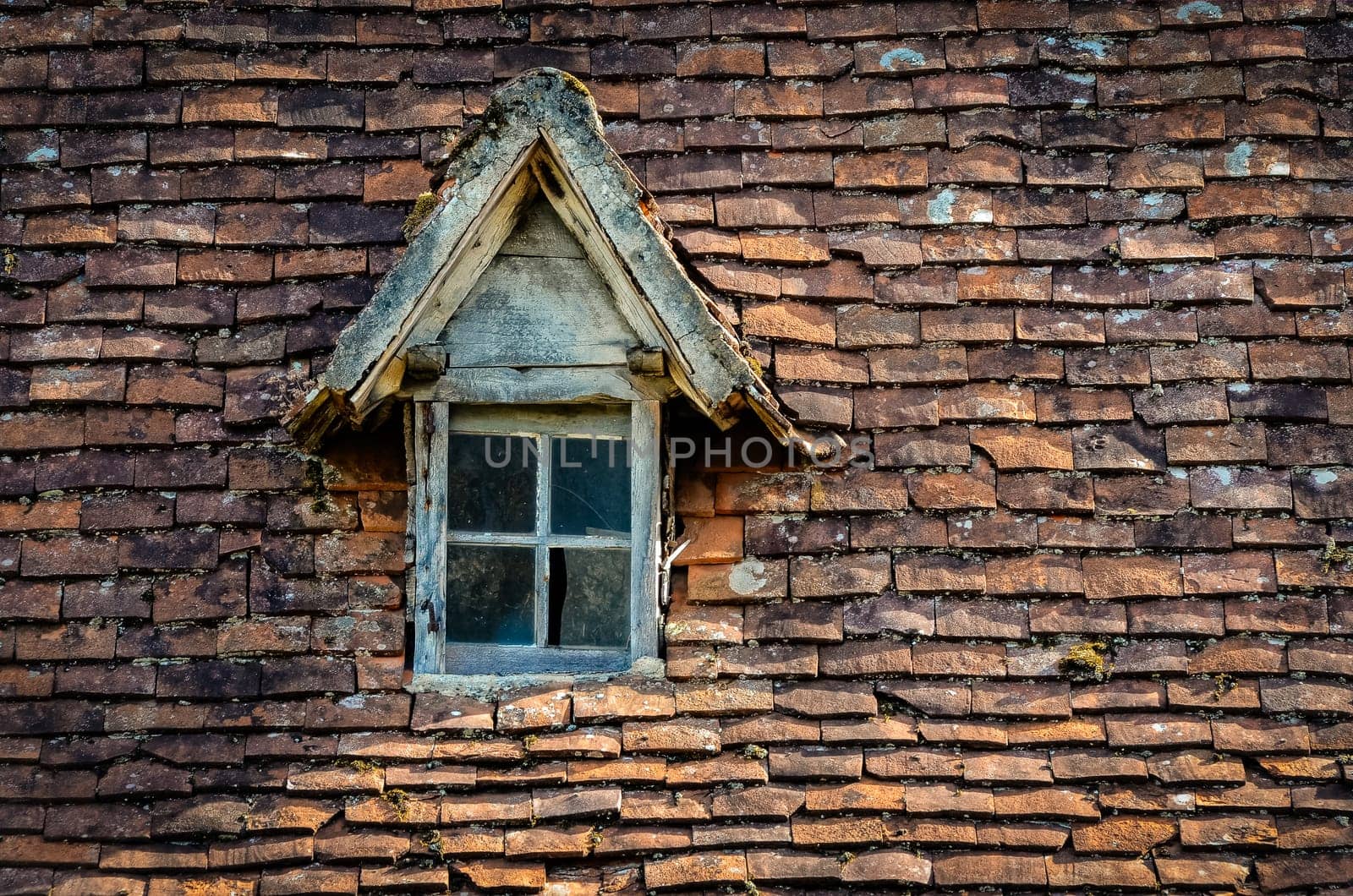 Old orange brick roof with broken glass retro winow