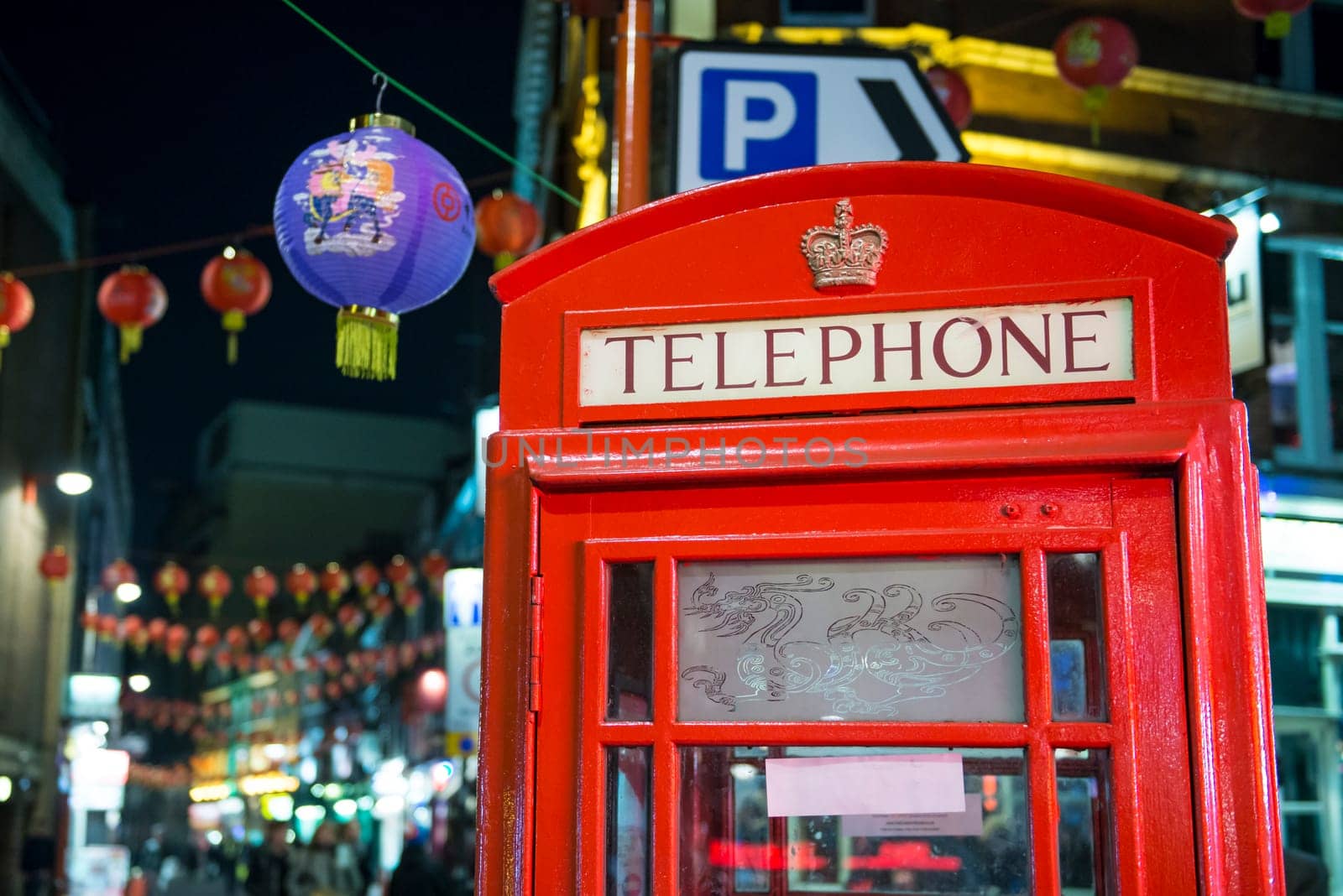 LONDON, UK - NOVEMBER 05: Detail of traditional red phone booth in Chinatown, the main Chinese commercial district in the city. November 05, 2012 in London.