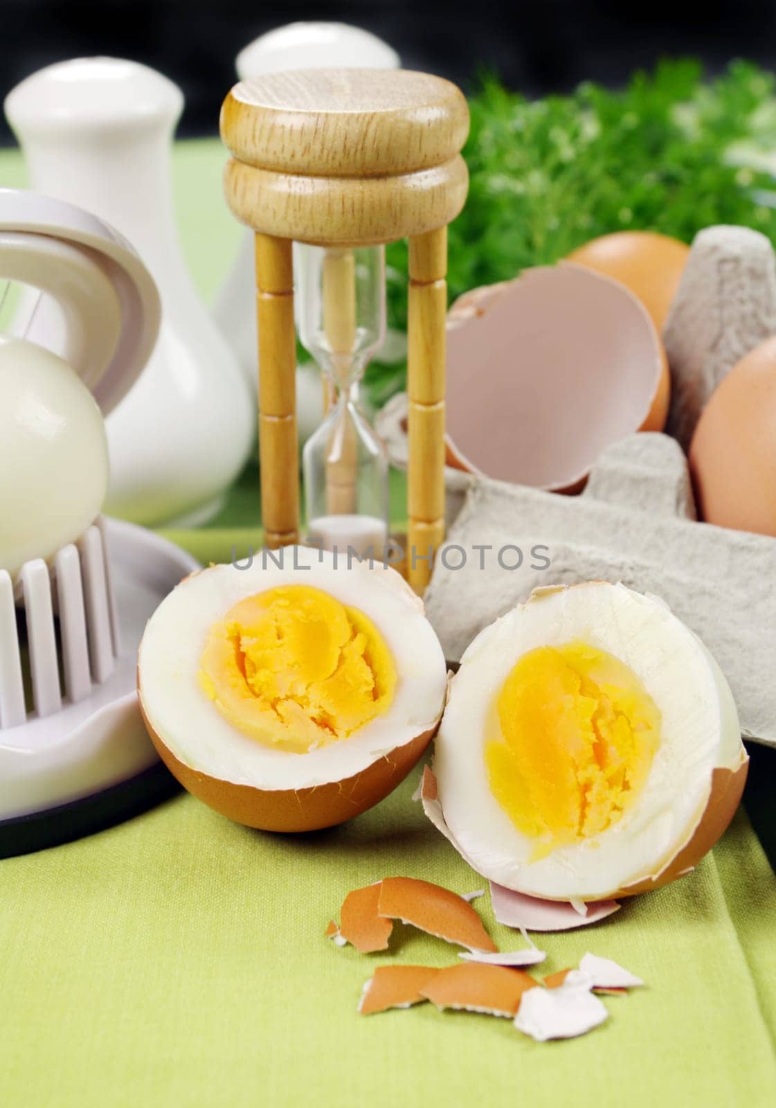 Cracked boiled egg with an egg timer ready to serve.