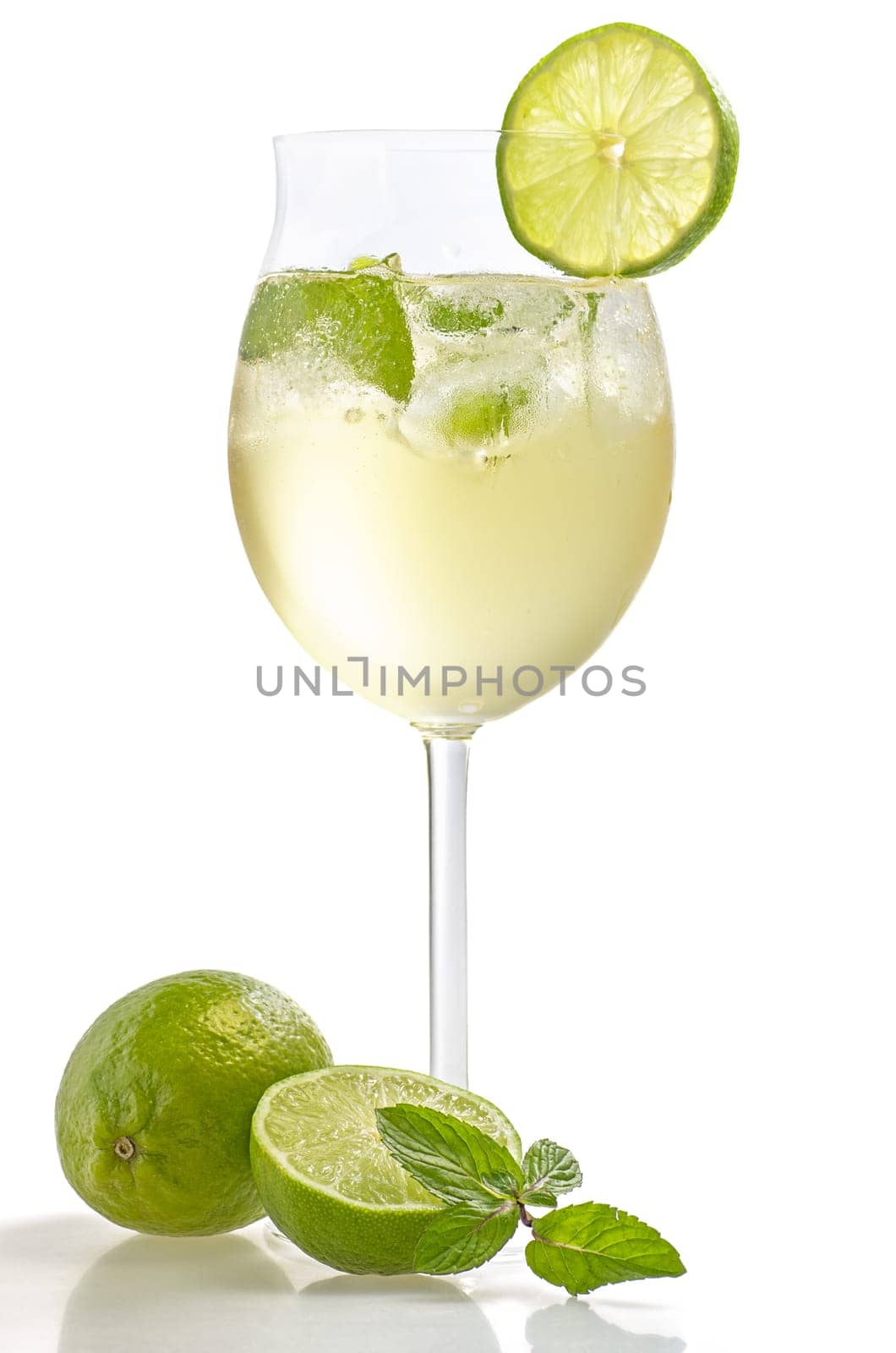 Aperitif with limes and mint in a wine glass