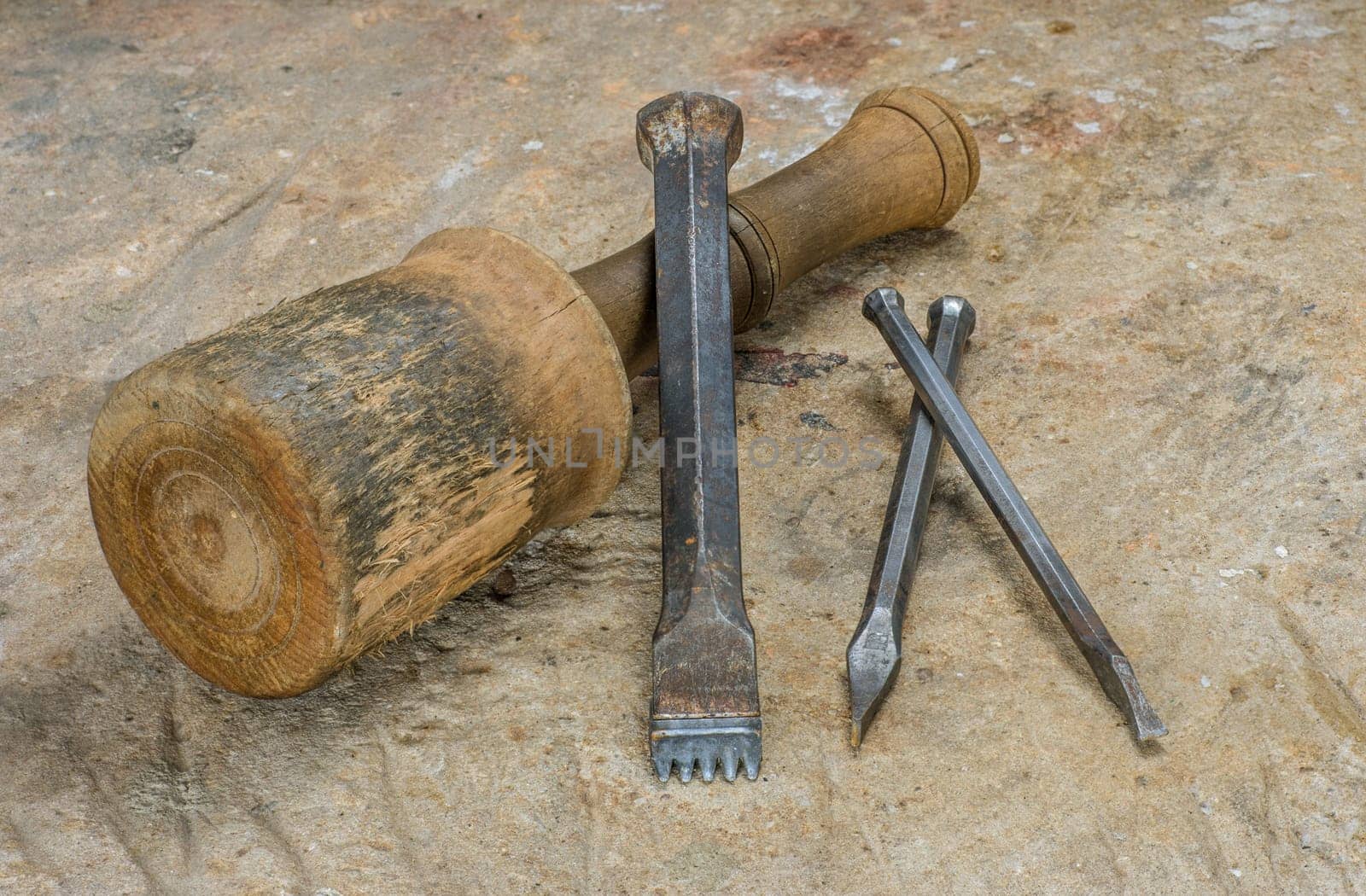 Clubs and chisels on a sandstone slab