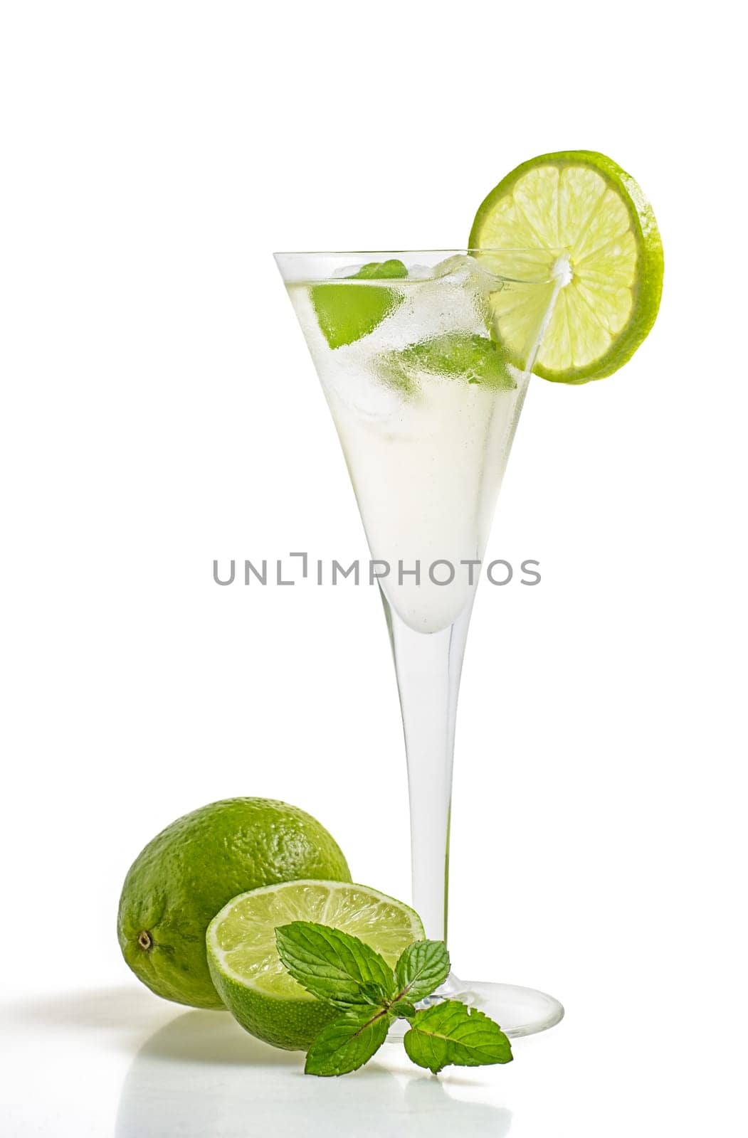 Aperitif with limes and mint in a champagne flute