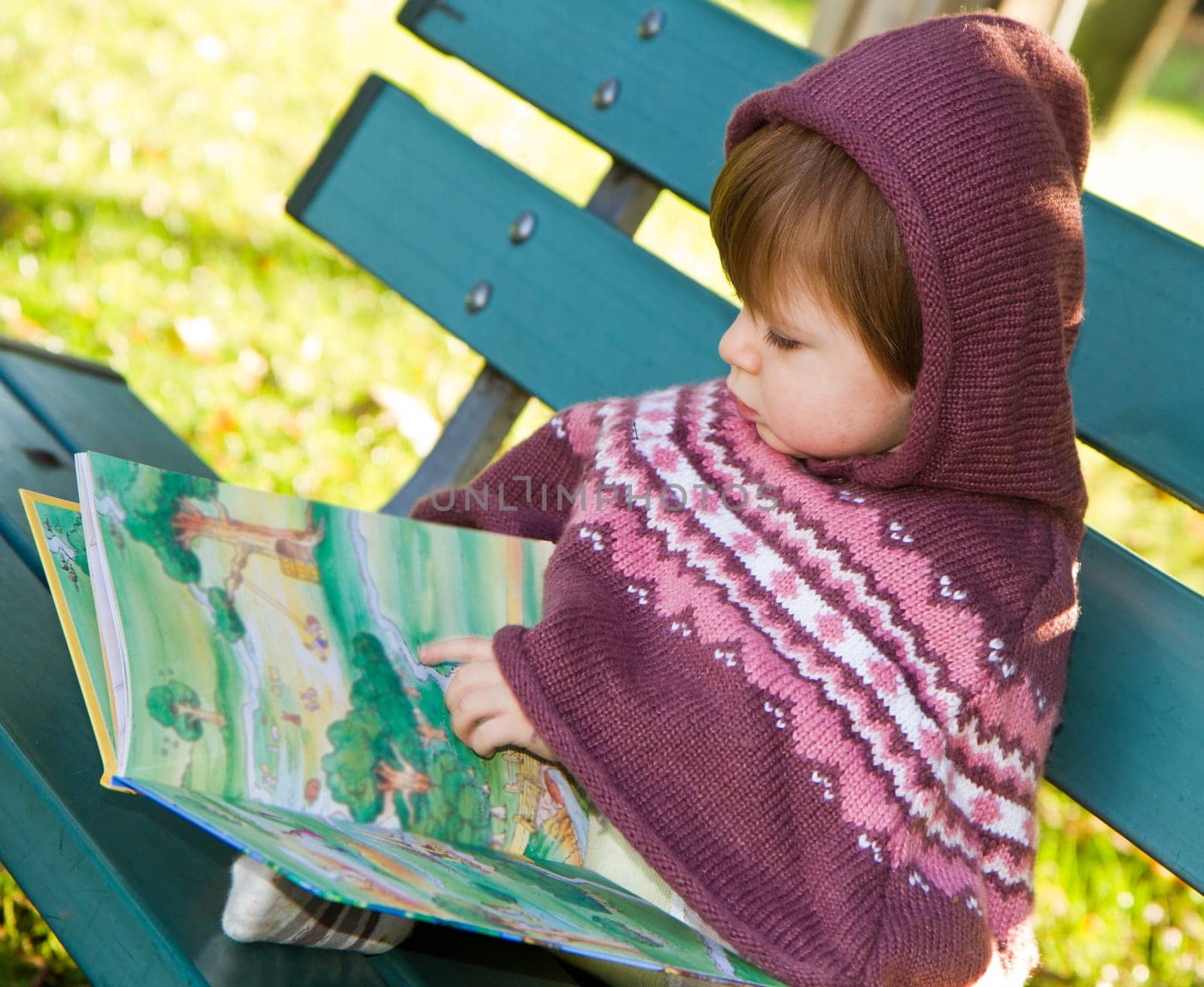 little girl reading a book