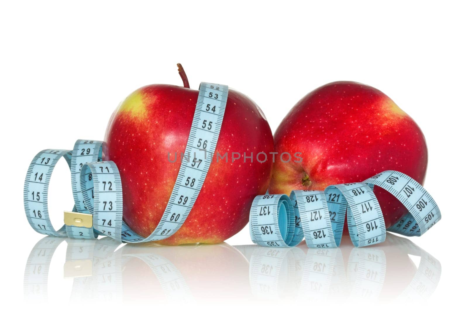 two red  apples wrapped by blue measure tape