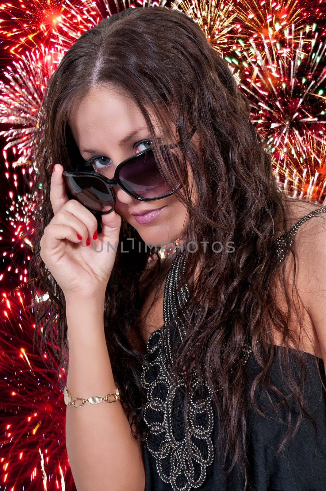 Beautiful woman holding a US flag at a fireworks display