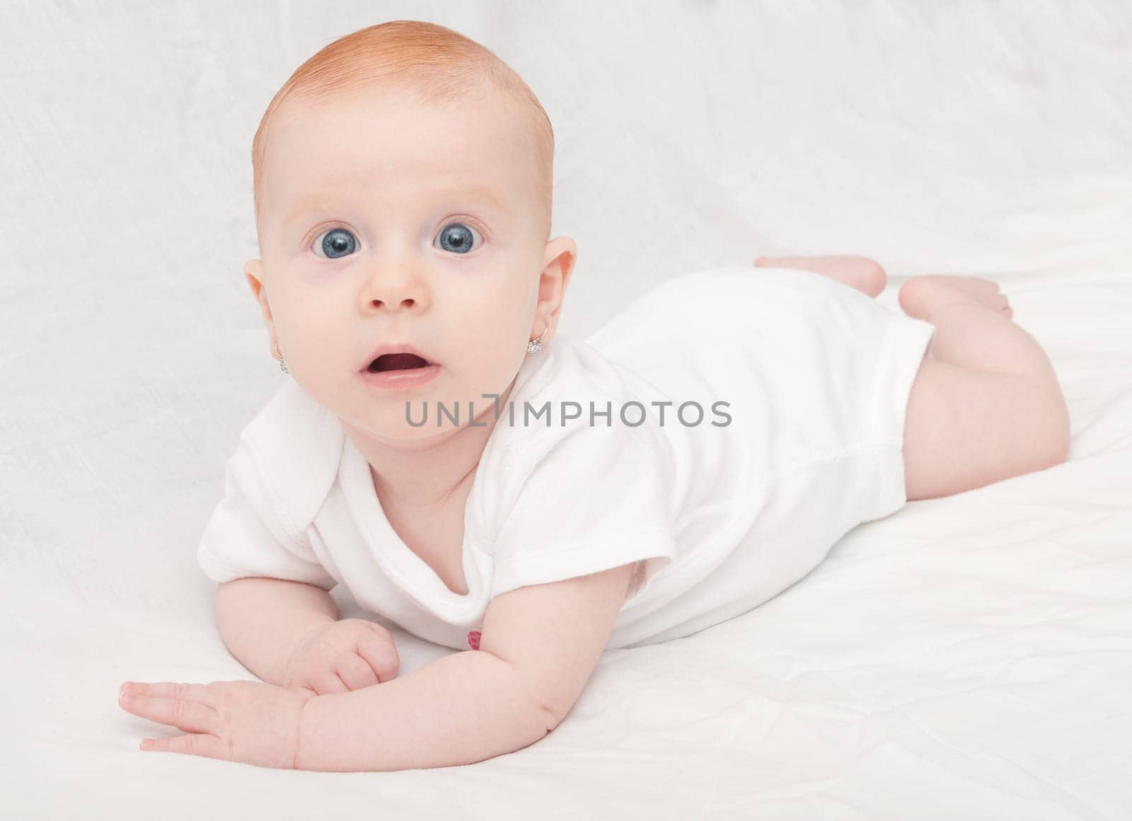 Cute Baby Girl Lying on Front on White Background