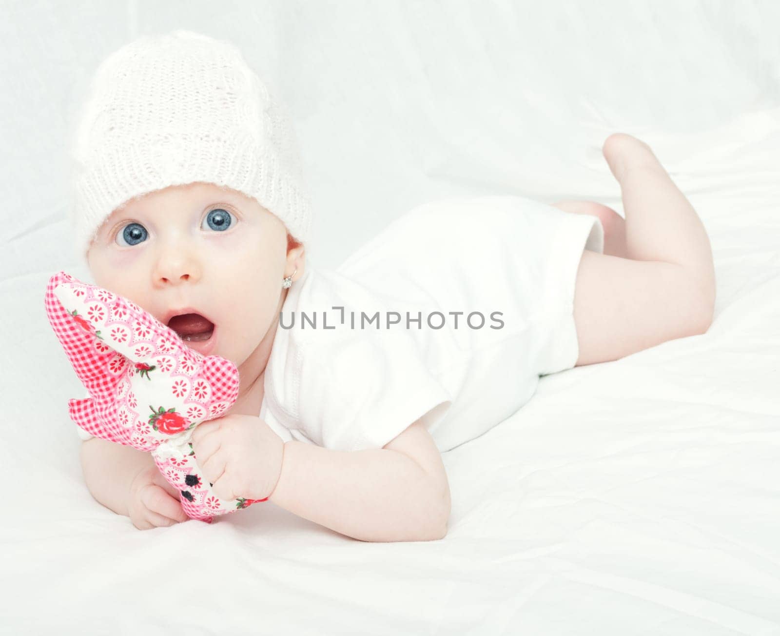 Cute Baby in Knitted Cap Girl Playing With Toy