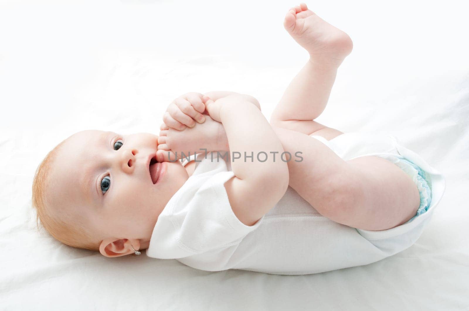 Cute Baby Girl Sucking Her Toes on White Background
