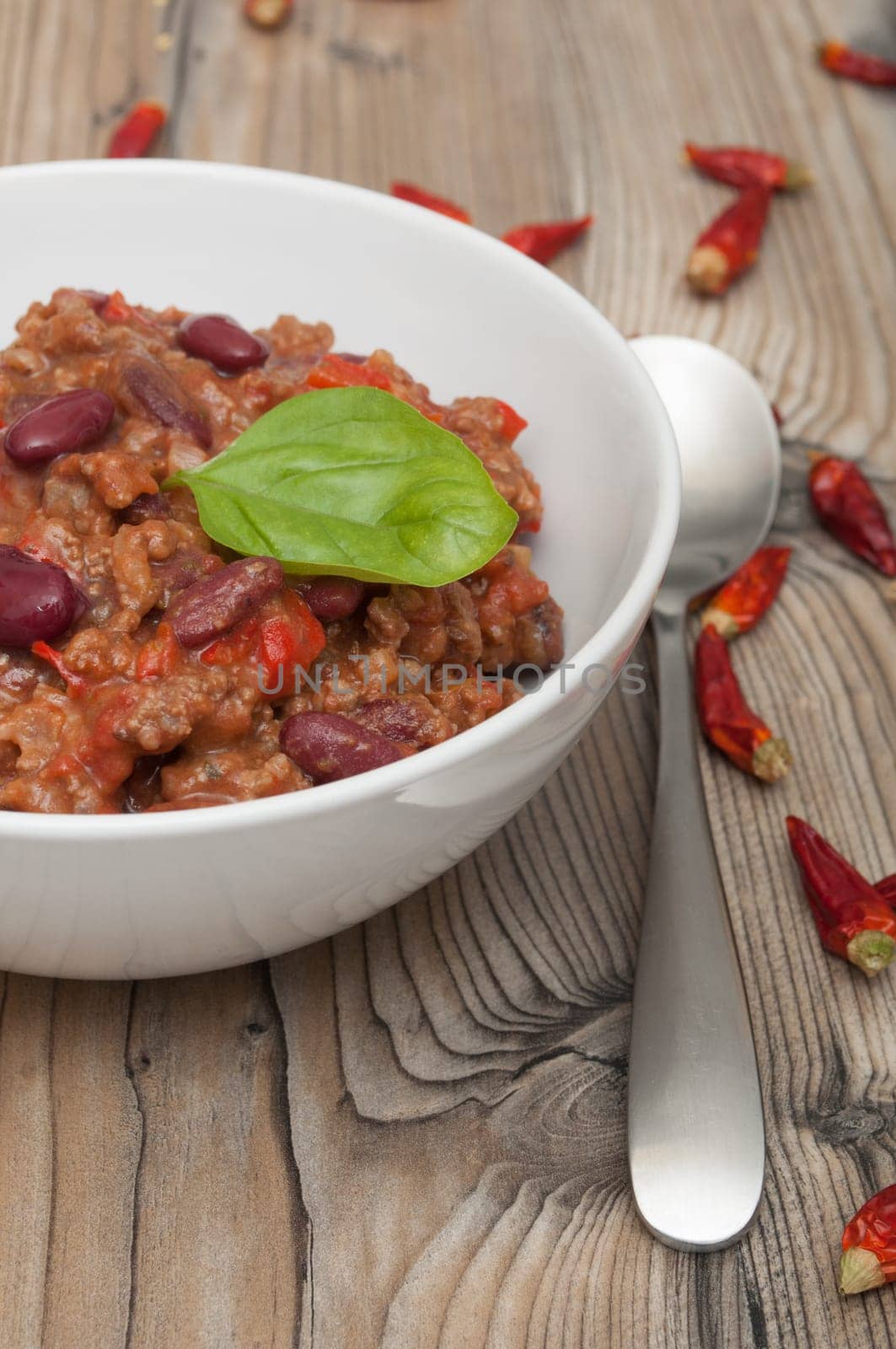 Chilli Con Carne in White Bowl and Red Chili Peppers