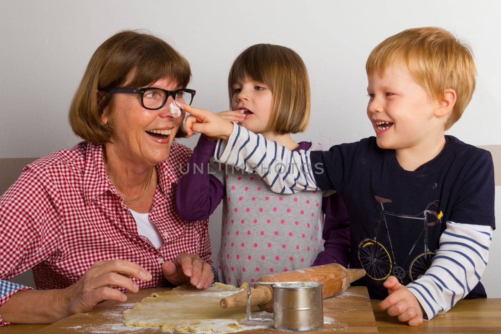 Grandma and her grandchildren baking