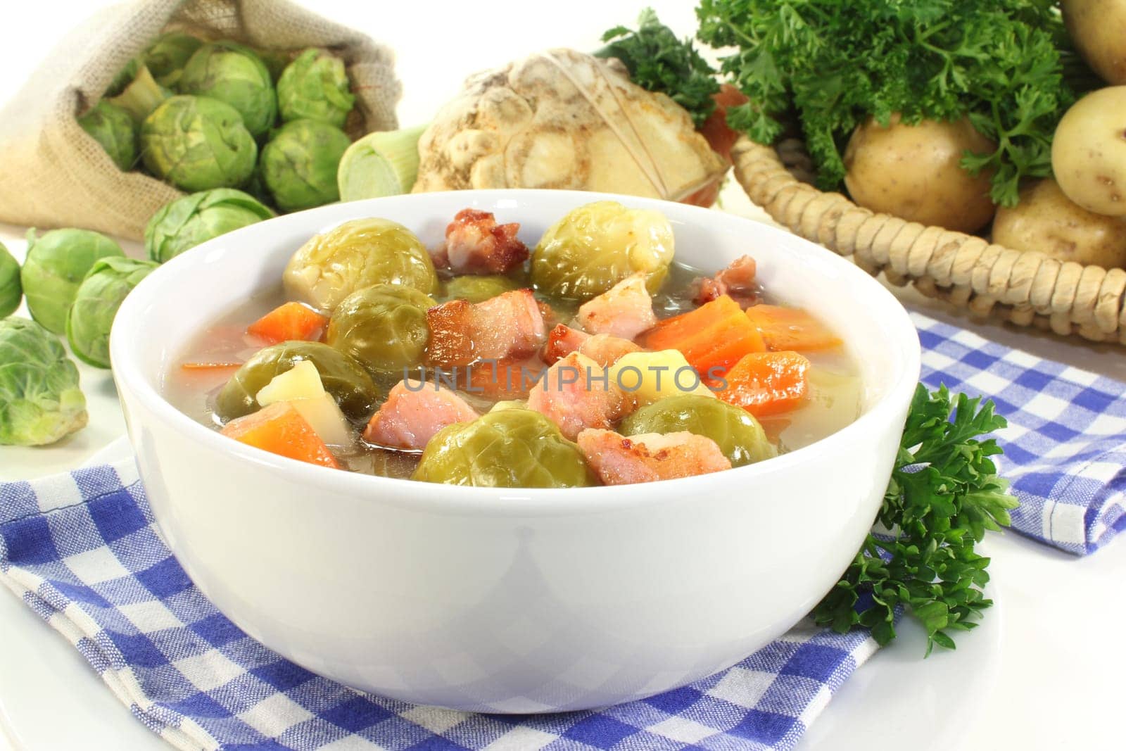 a bowl of Brussels sprout stew with colorful vegetables and bacon