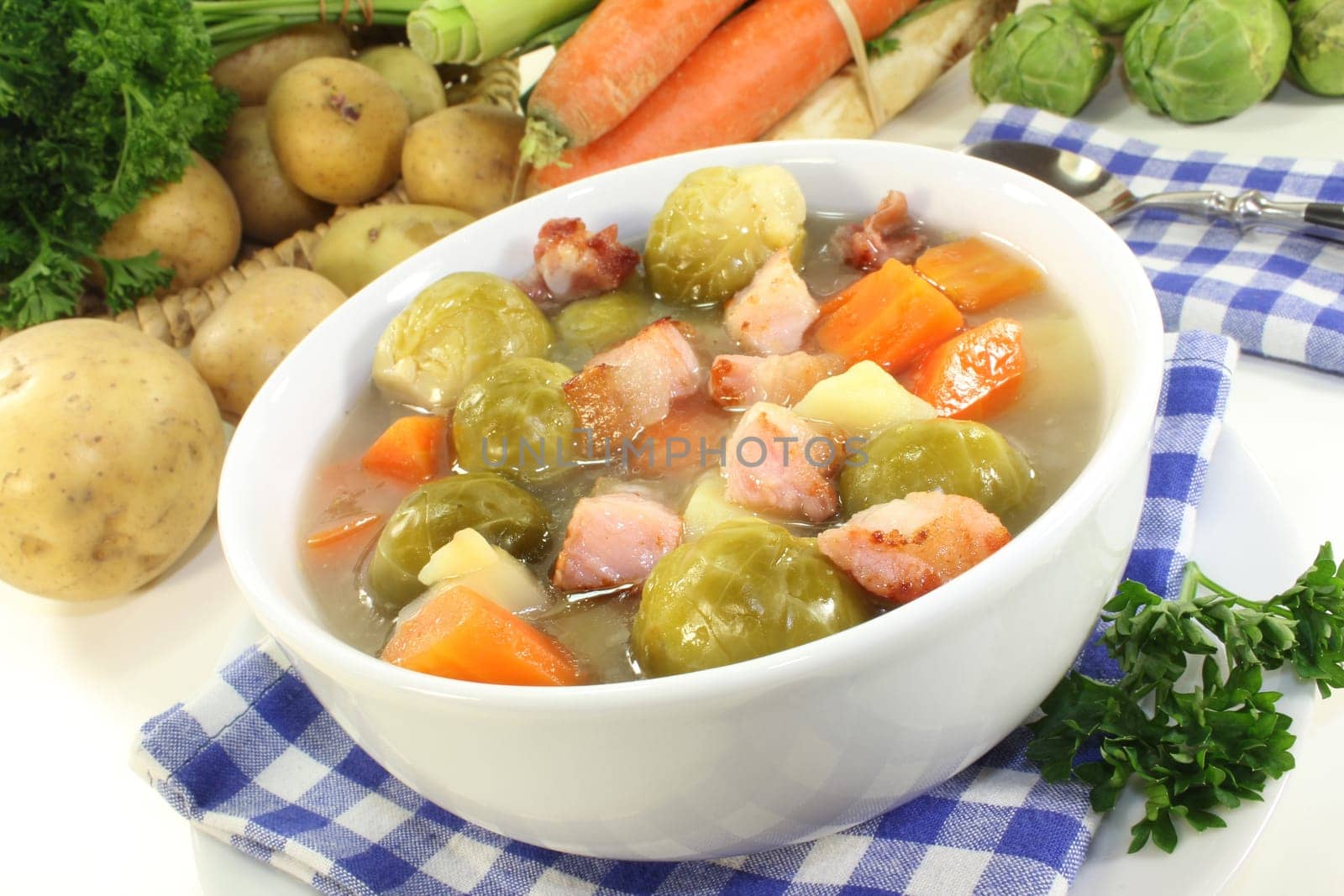 a bowl of Brussels sprout stew with colorful vegetables and bacon