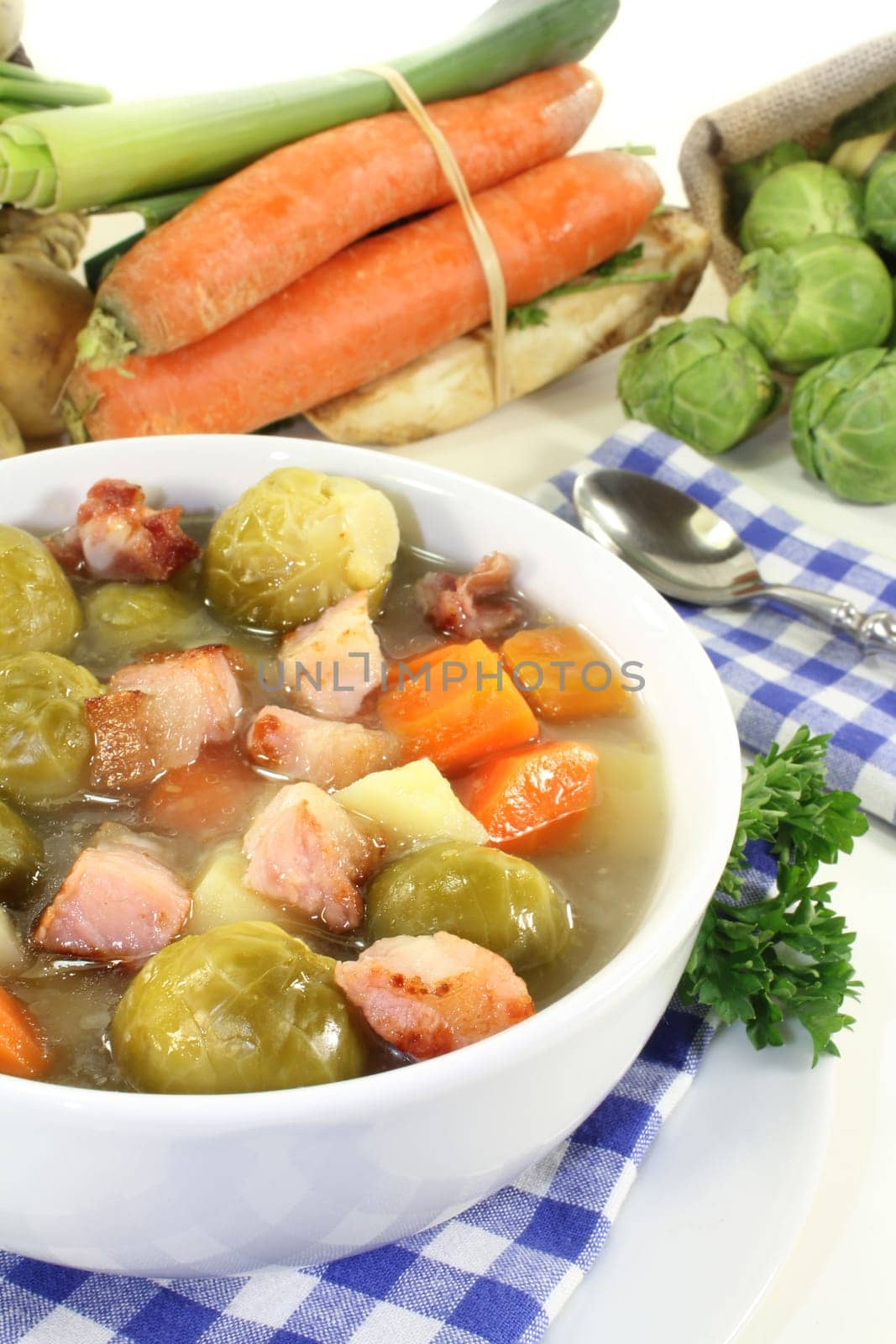 a bowl of Brussels sprout stew with colorful vegetables and bacon