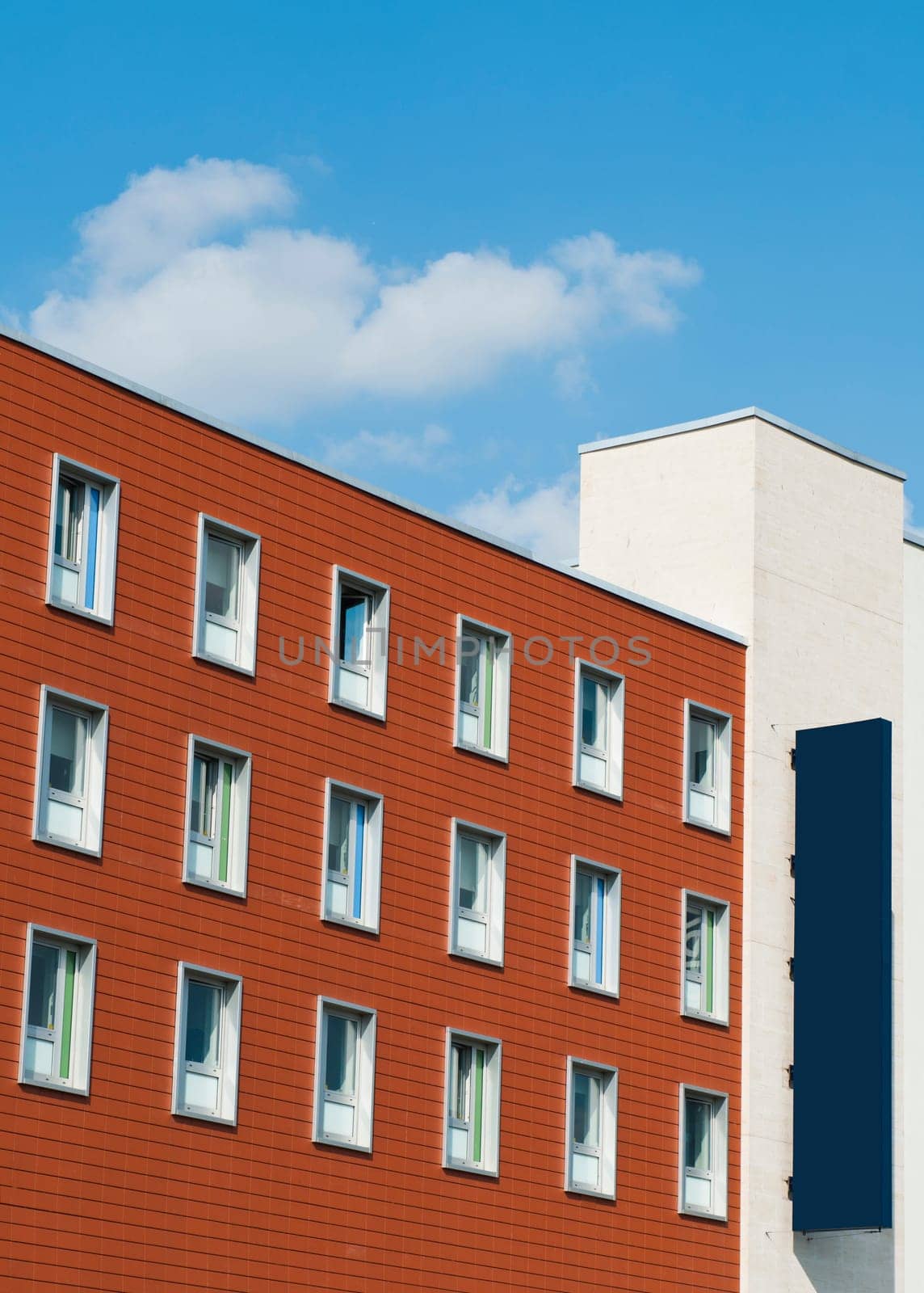 blue blank billboard on a modern building in the city (suitable for hotel, office or shopping mall) ready for your design