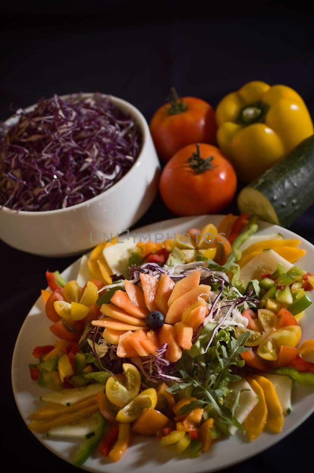 Mixed green salad with raw fruits and vegetables