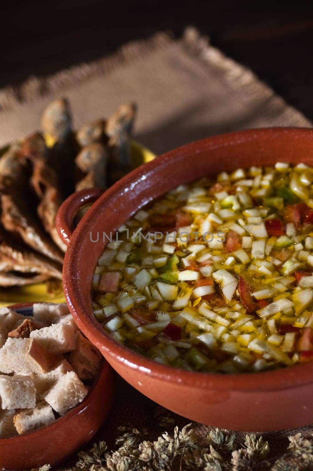 Real food photographed on location in traditional portuguese restaurants, cold soup gaspacho with fried horse mackerel - gaspacho com carapaus fritos - Alentejo, Portugal