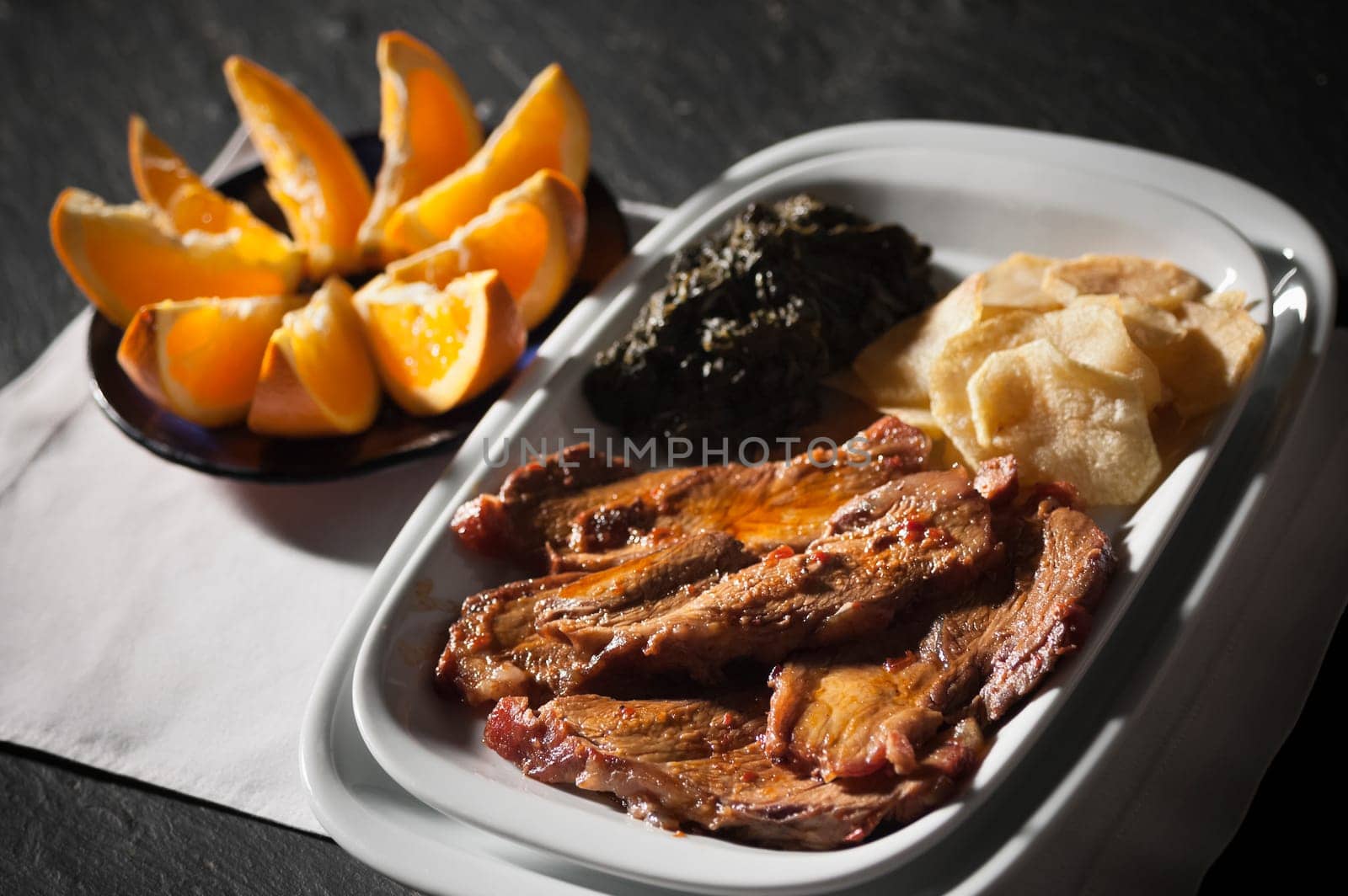 Real food photographed on location in traditional portuguese restaurants, pork fillet seasoned with red bell pepper garnished with mashed spinach, Alentejo, Portugal