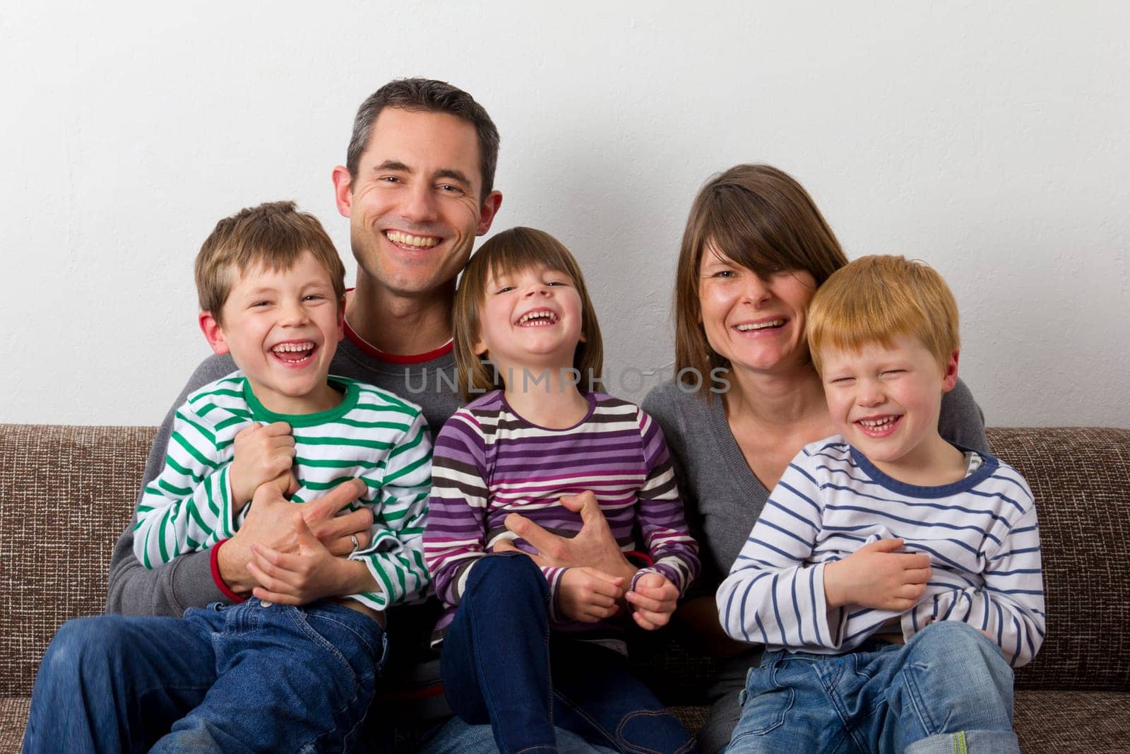 Laughing family on the sofa