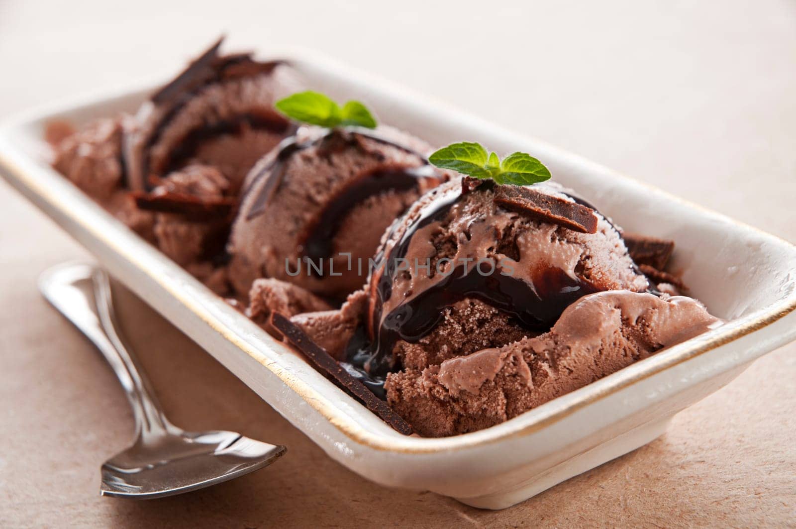 Chocolate ice cream with syrup close up