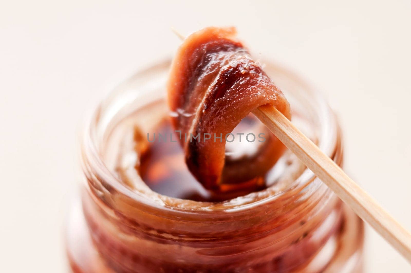 Fresh anchovie on toothpick close up shoot