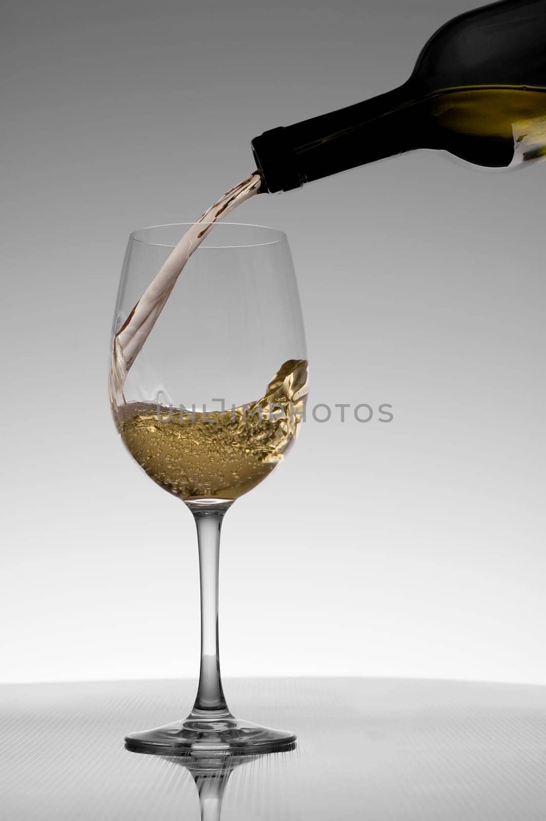 White wine pouring into a glass close up