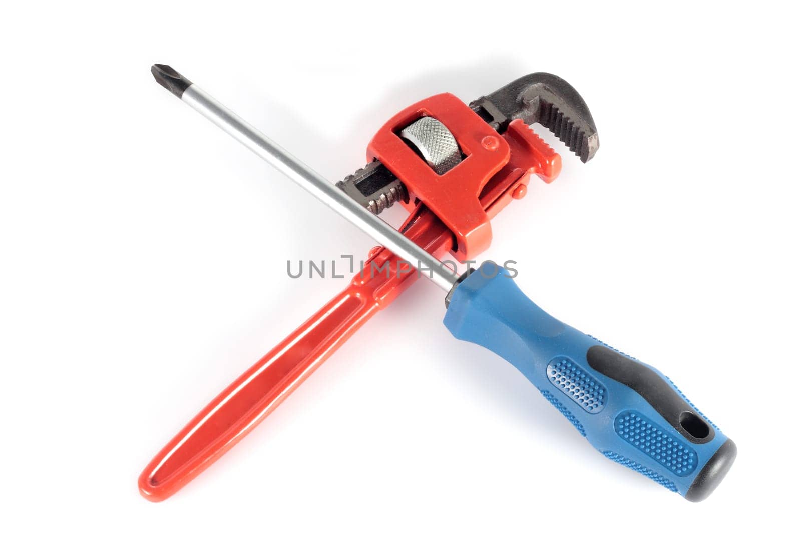repair and maintenance concept with screwdriver and adjustable wrench crossed on white background