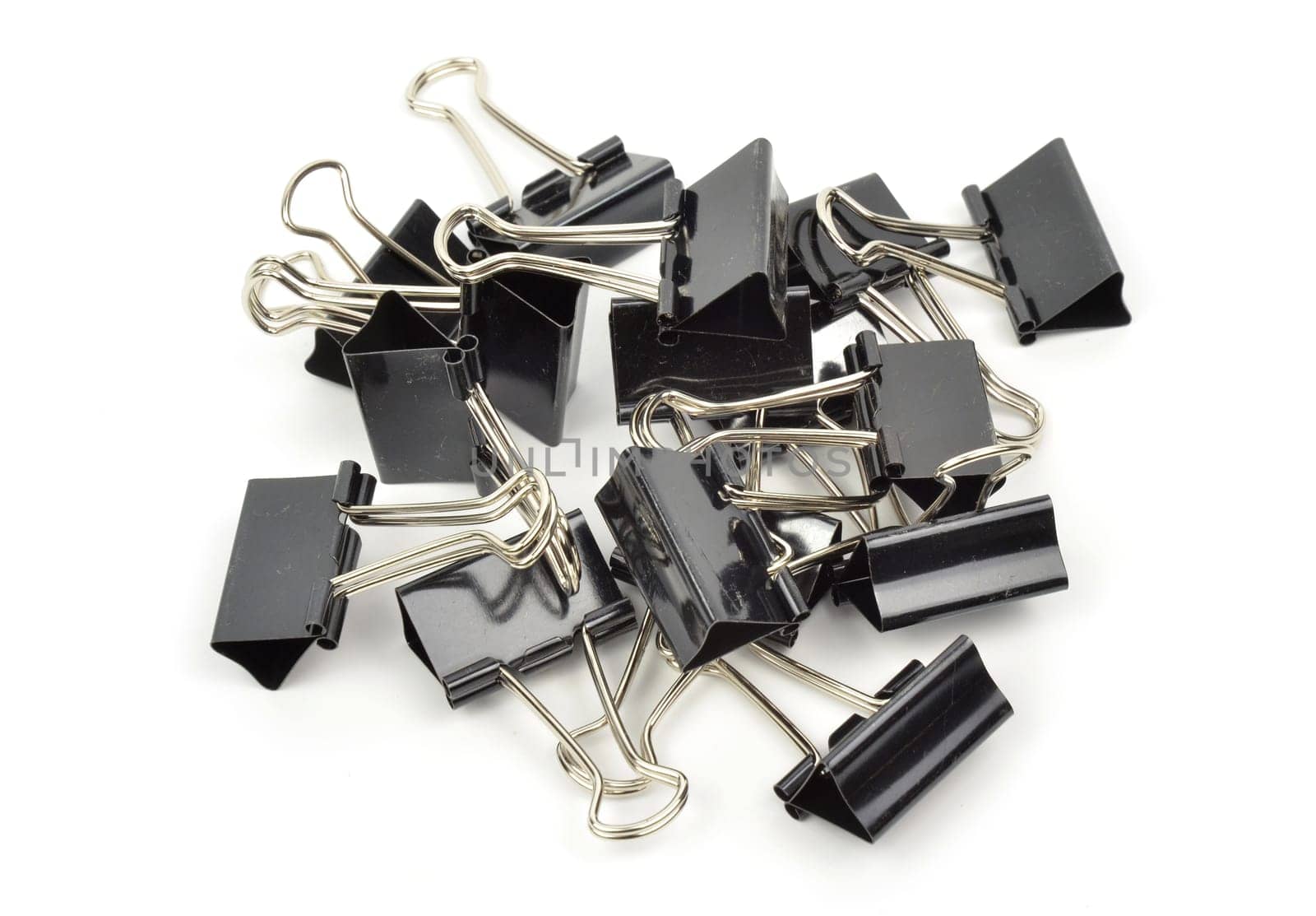 A black binder clip against a white background