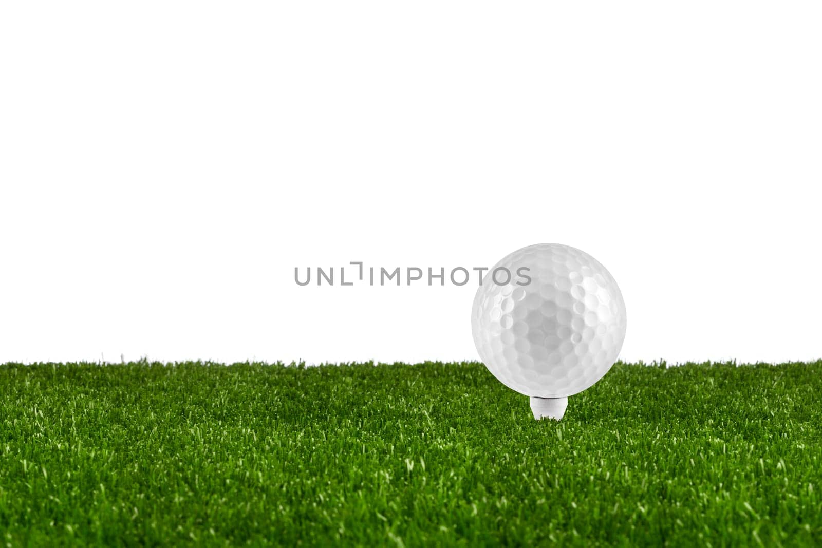 Golf ball on tee on the green