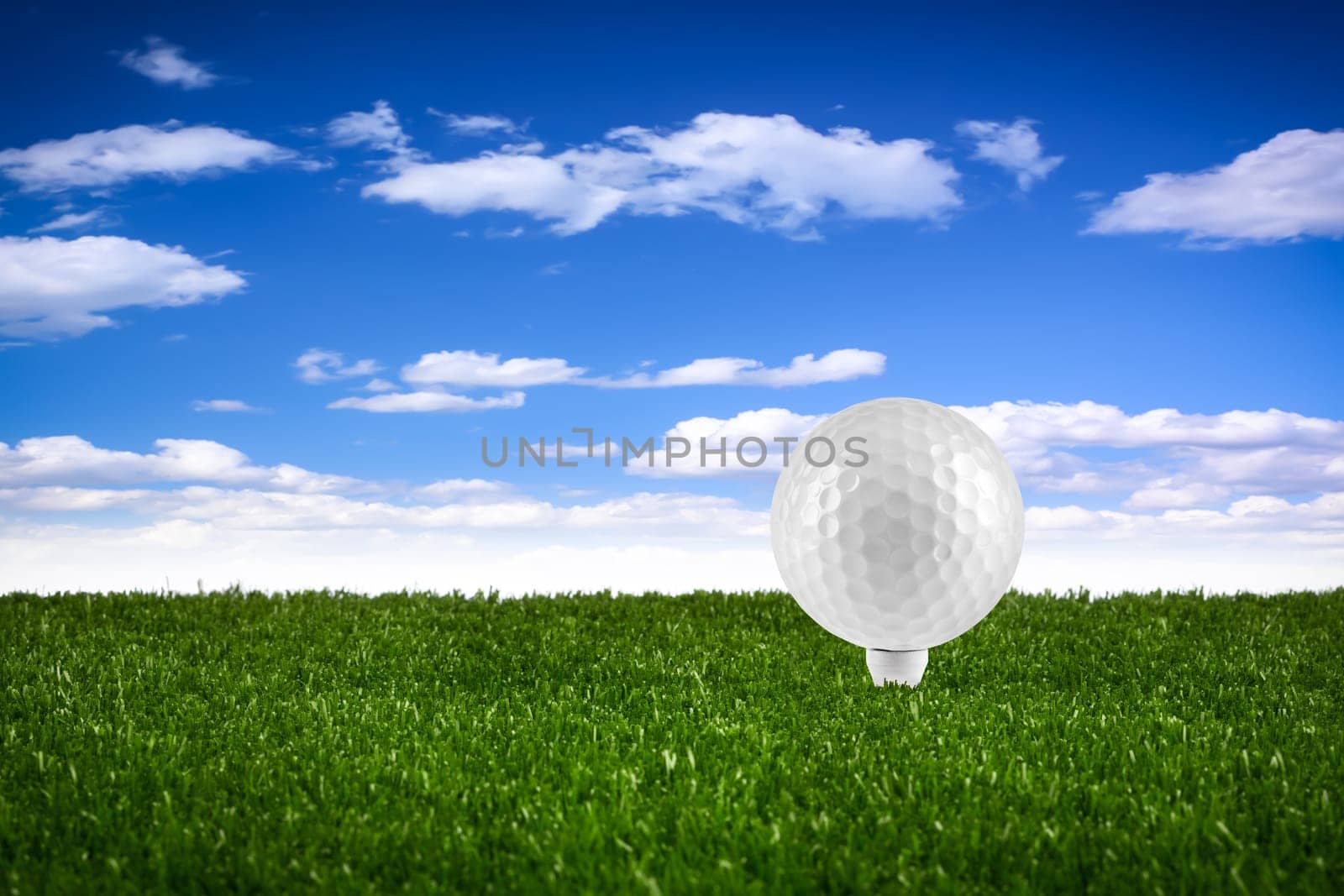 Golf ball on tee on the green