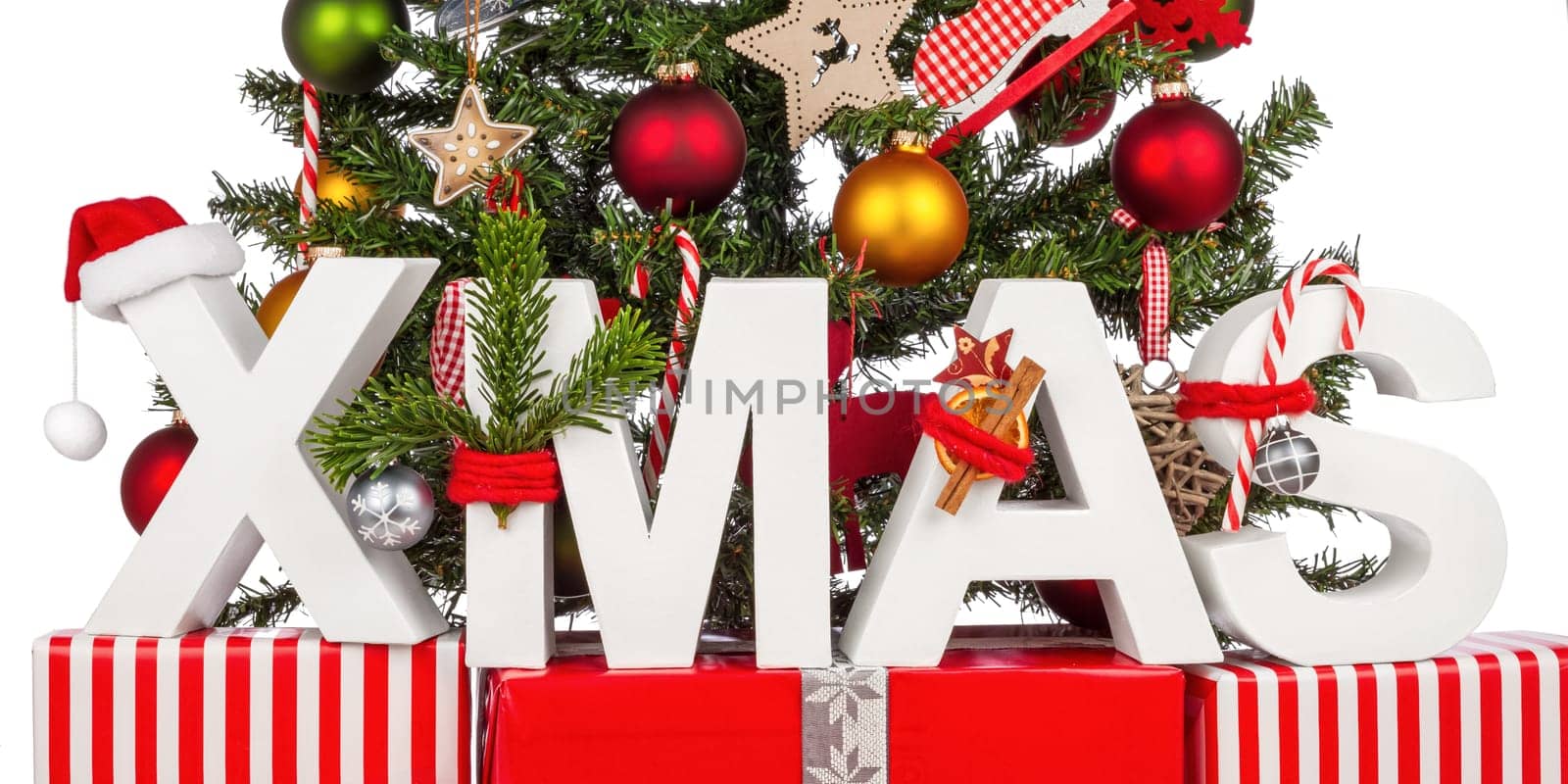 XMAS lettering on gifts in front of Christmas tree